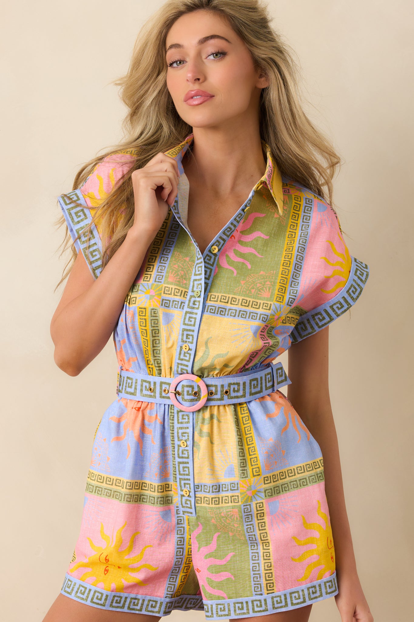 Focused view of the waist area featuring a coordinating belt with a bold buckle that defines the silhouette.