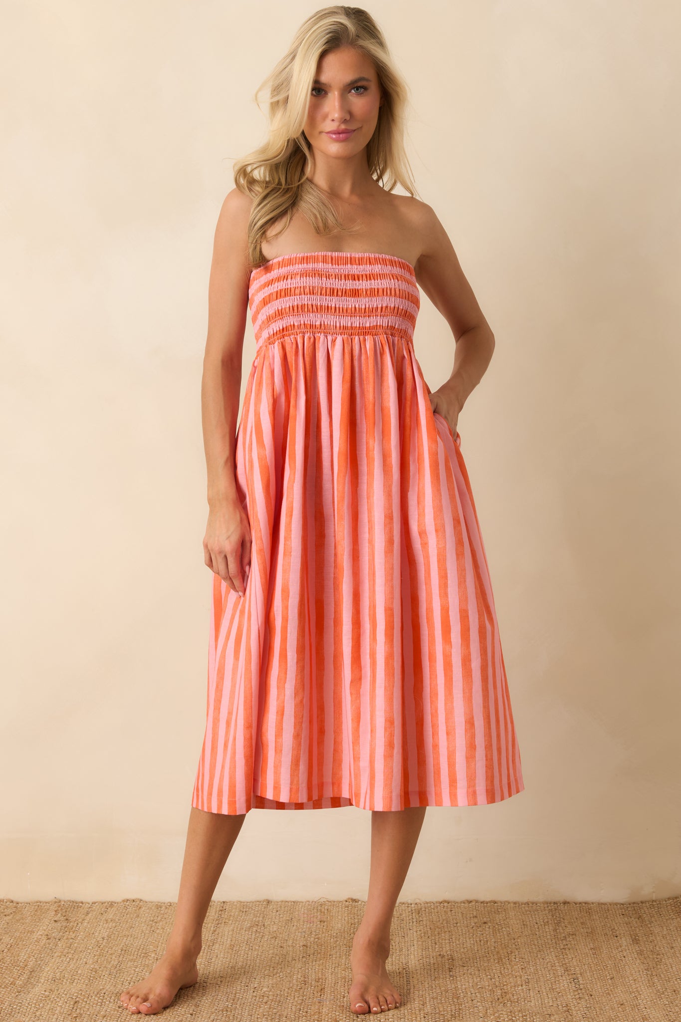 Convertible strapless dress with a soft drape, vertical stripe pattern, and relaxed fit throughout the skirt.