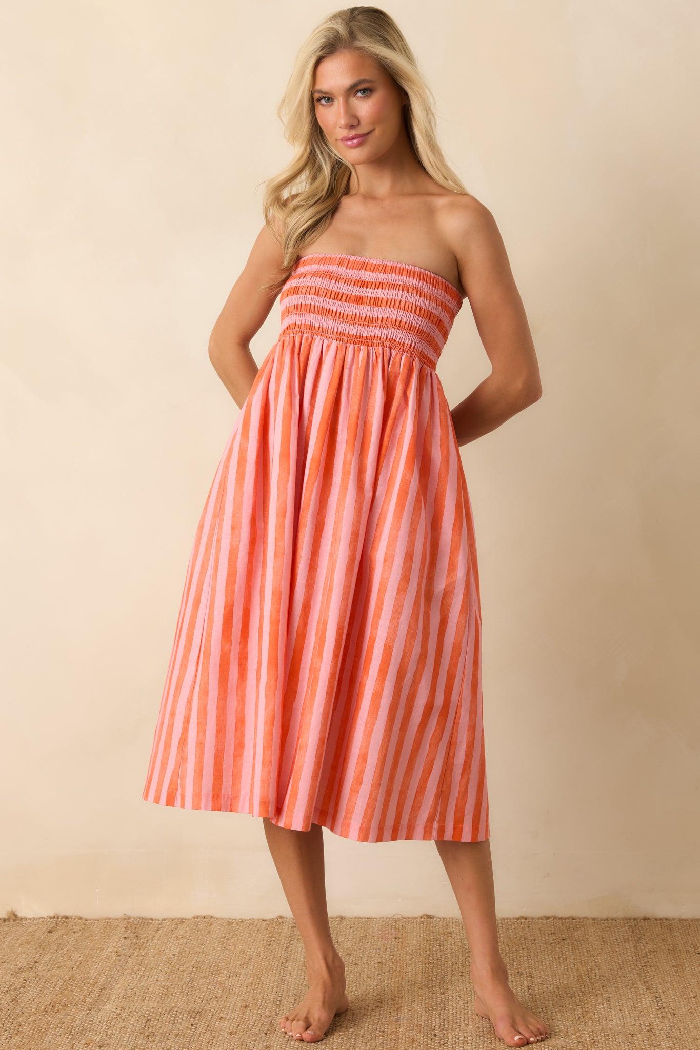 Lightweight striped midi dress featuring a smocked top and casual, effortless silhouette ideal for warm weather.