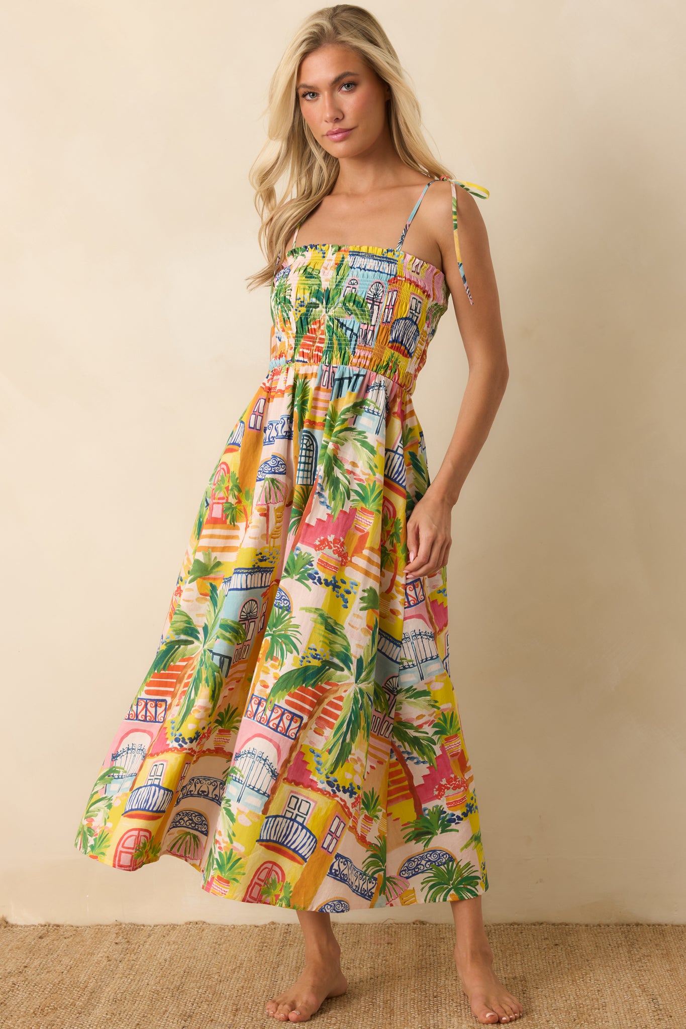 Colorful scenic print midi dress showcasing a stretchy smocked bodice and an airy skirt with effortless movement.