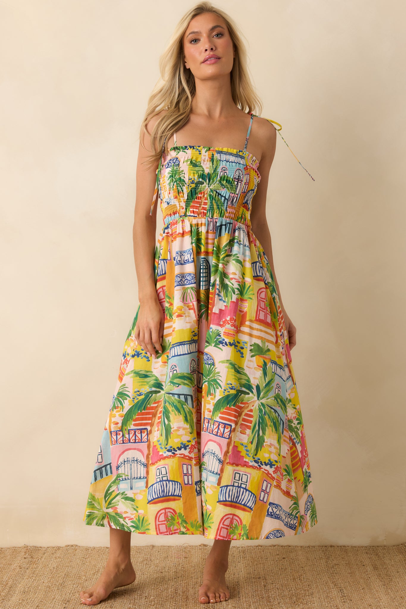 Lightweight printed midi dress with a fully smocked bodice, practical side pockets, and a vibrant multi-color design.