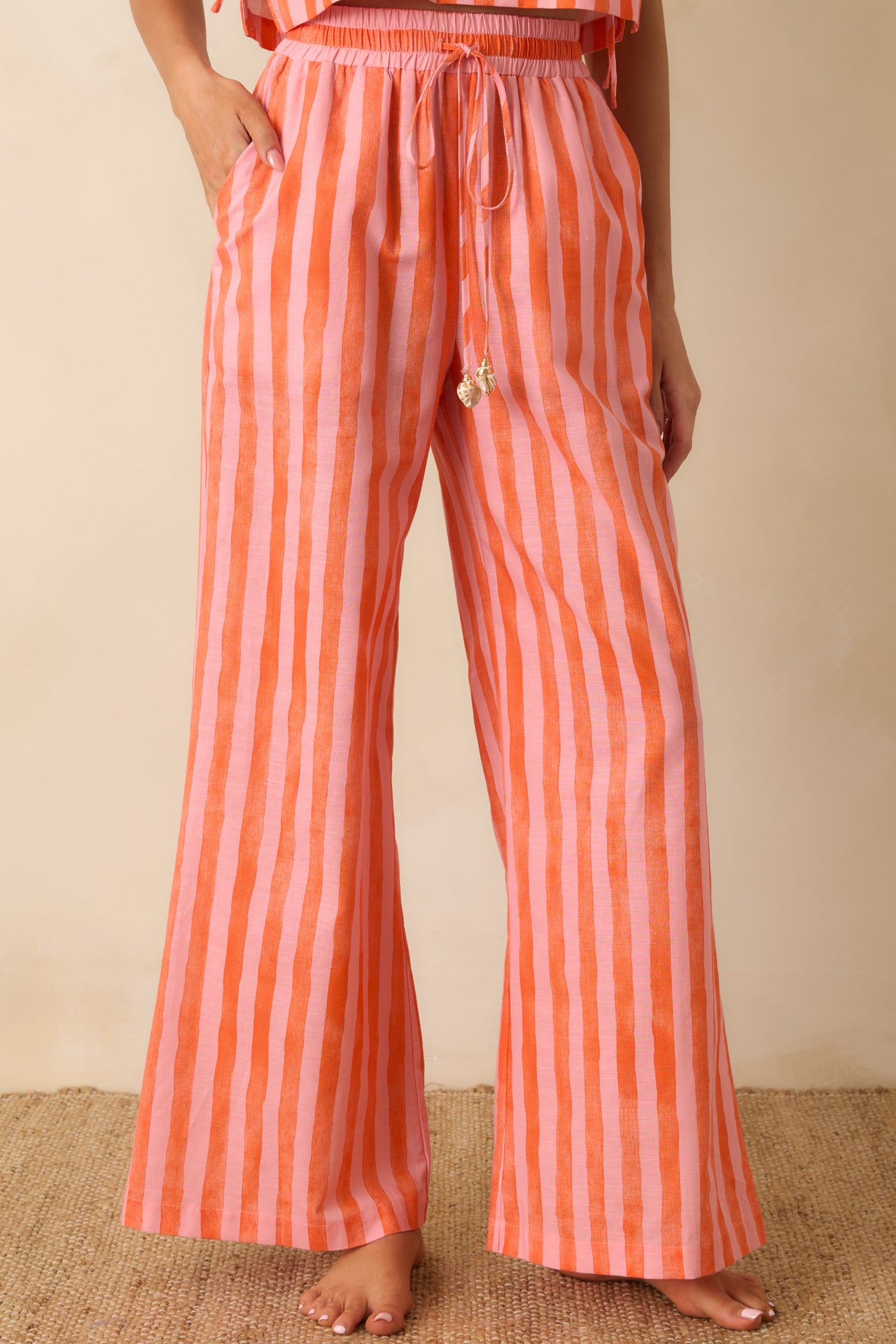 Detailed look at the high-rise elastic waistband and adjustable drawstring tie with shell-inspired bead accents.