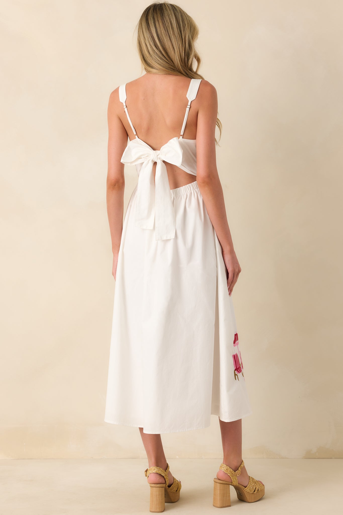 Rear view of the dress showcasing the flowing skirt, defined waistband, and clean back silhouette.