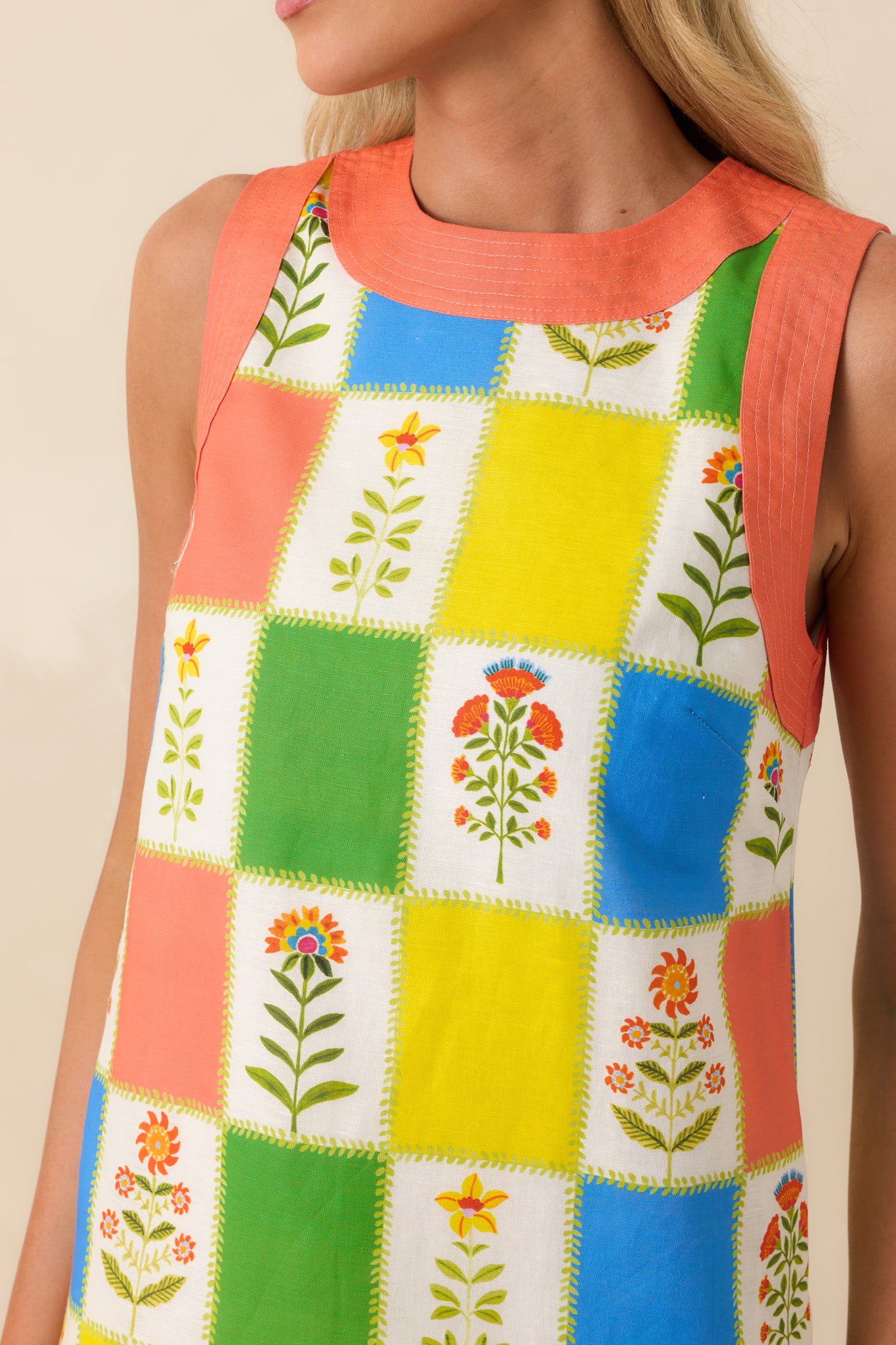 Tight focus on the vibrant patchwork floral print, showcasing the mix of bold hues and delicate botanical motifs across the fabric.