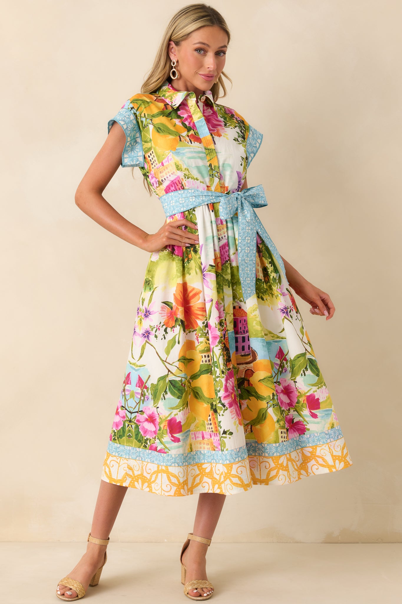 Tailored midi dress with collared neckline and soft blue trim at sleeves and hem.
