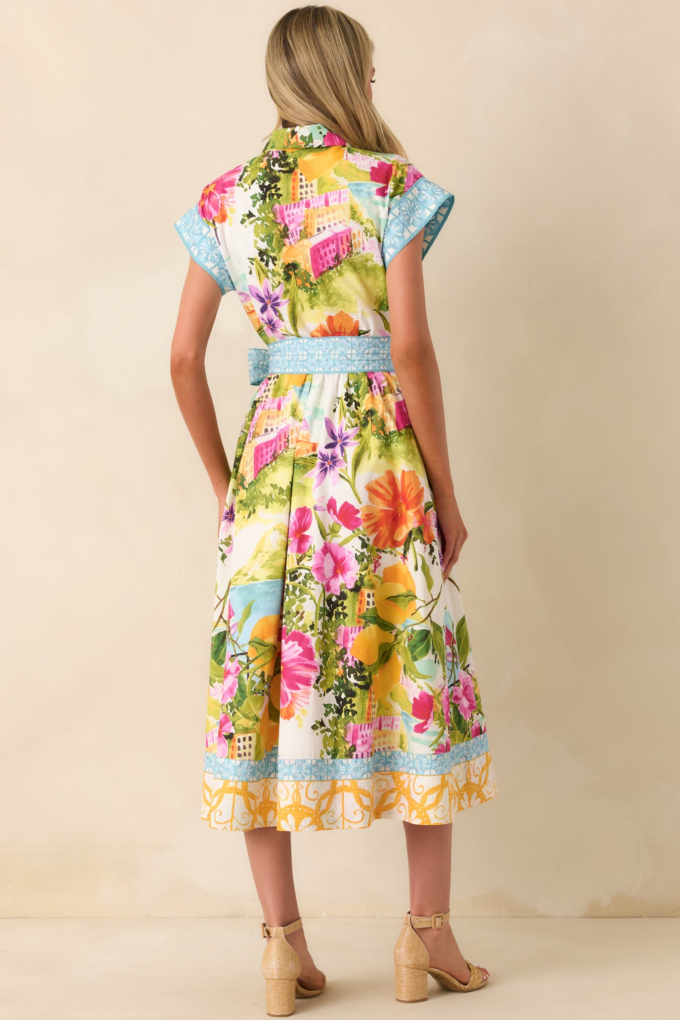 Rear view of midi dress with cinched waist and softly flowing skirt silhouette.