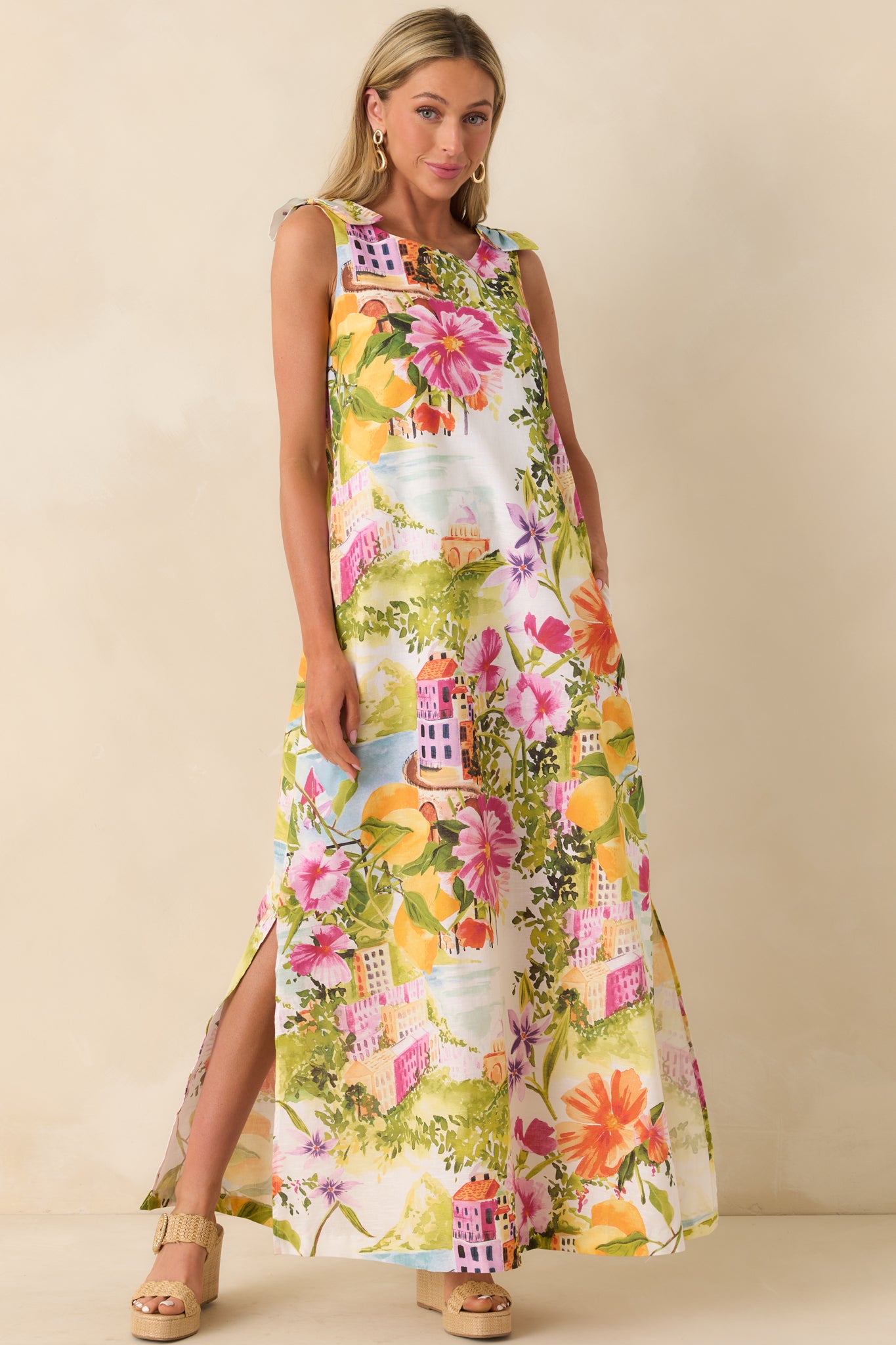 Linen-cotton maxi dress with village print, sleeveless design, and airy drape.
