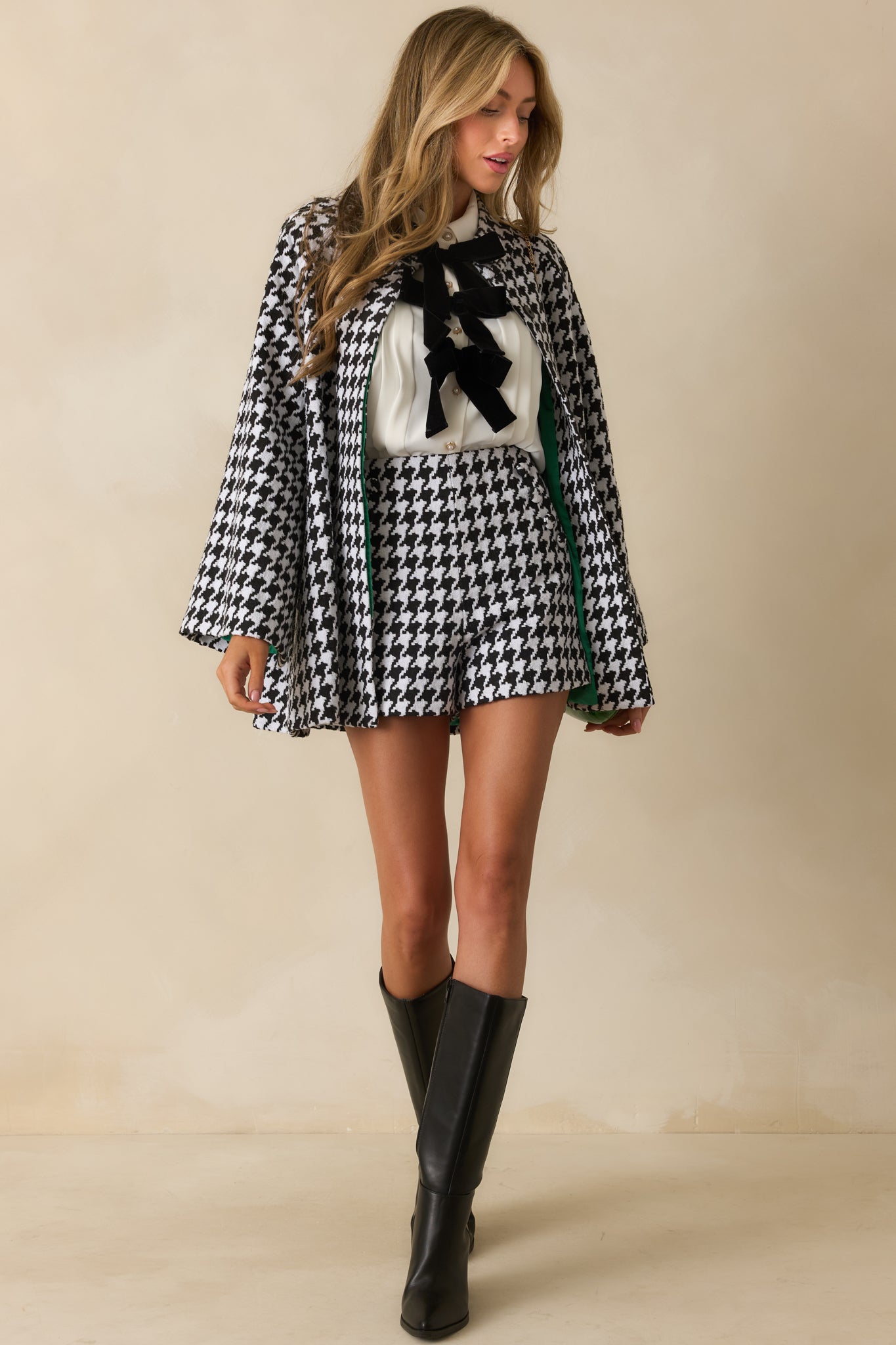 Structured houndstooth coat displaying long sleeves, collared neckline, and polished hip-length fit.