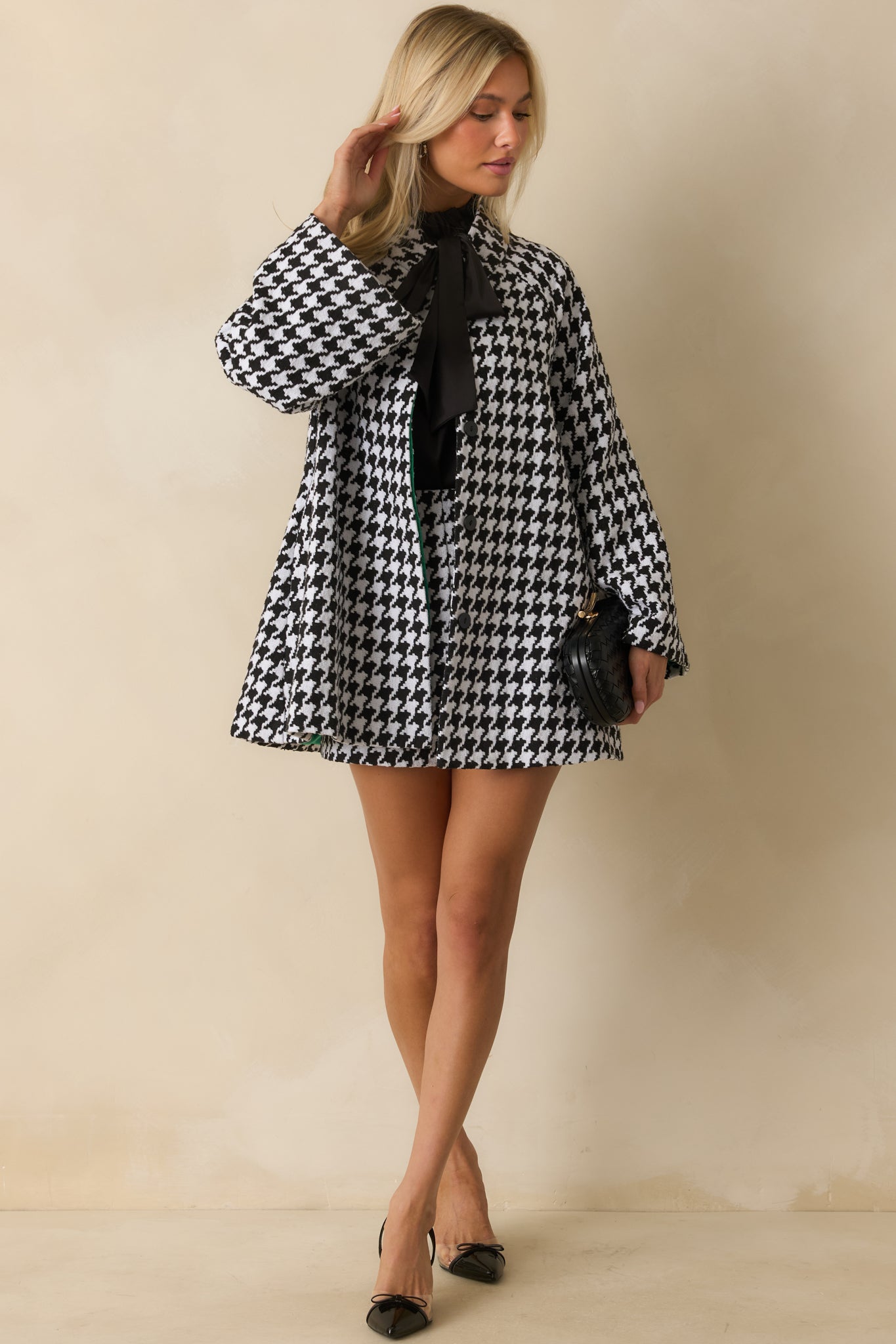 Woven black-and-white coat highlighting a polished silhouette and fully lined interior.