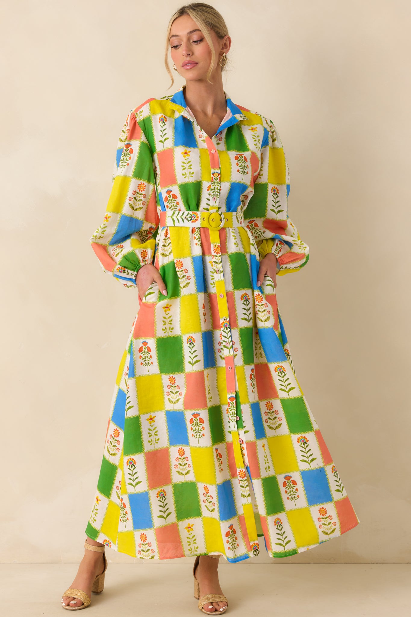 Maxi dress showcasing long sleeves with subtle volume at the cuffs, paired with a tailored bodice and a softly flared full-length skirt for balanced structure and movement.