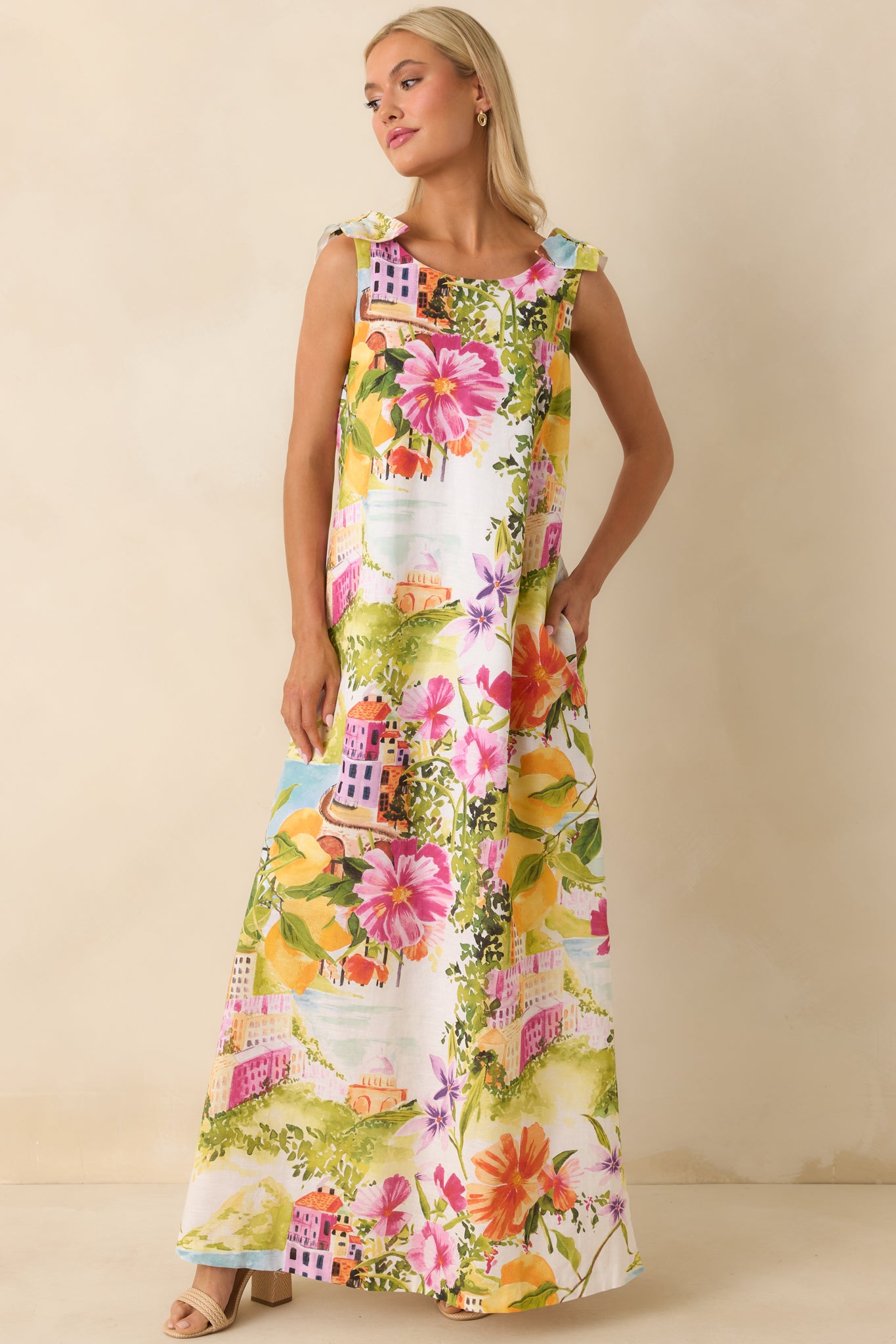 Coastal postcard print maxi dress with shoulder tie straps and flowing fit.
