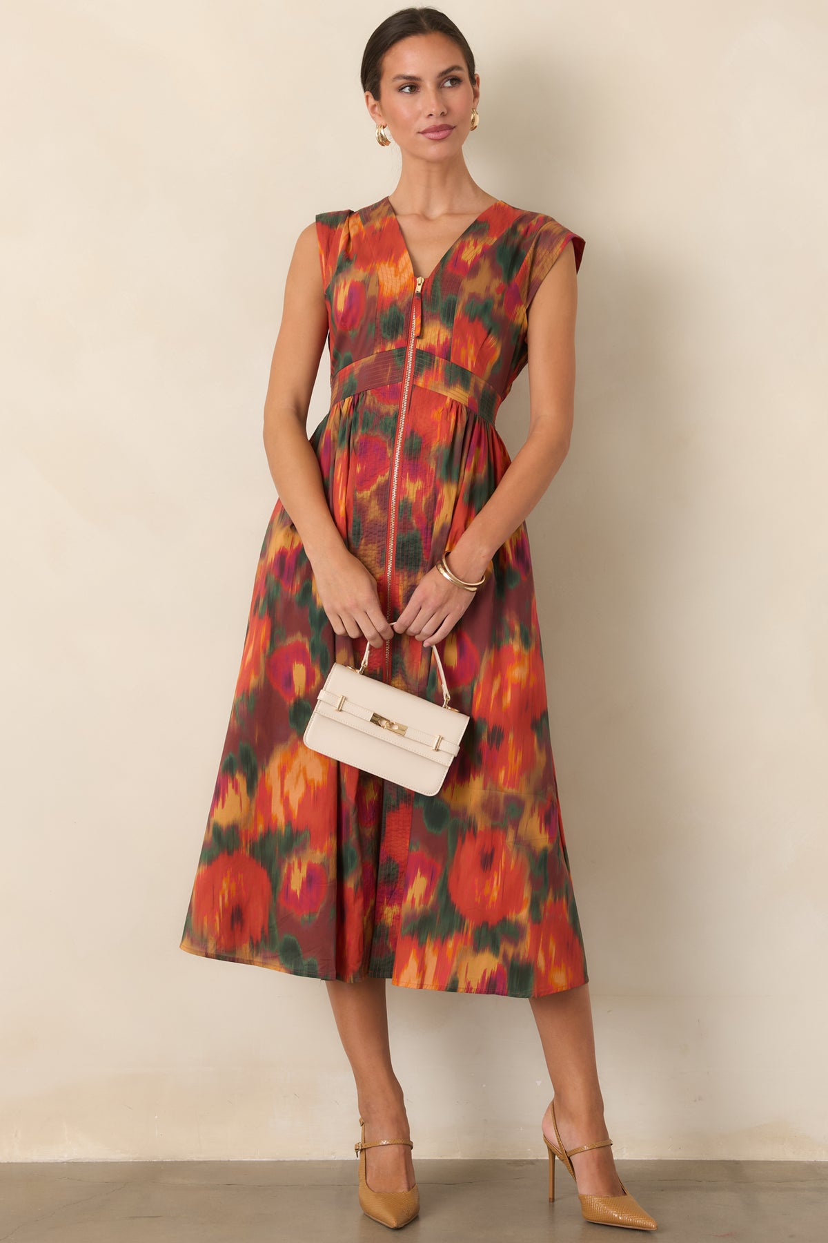 Painterly rust floral midi dress designed with a fitted bodice, defined waist, gathered skirt, and polished front zipper.