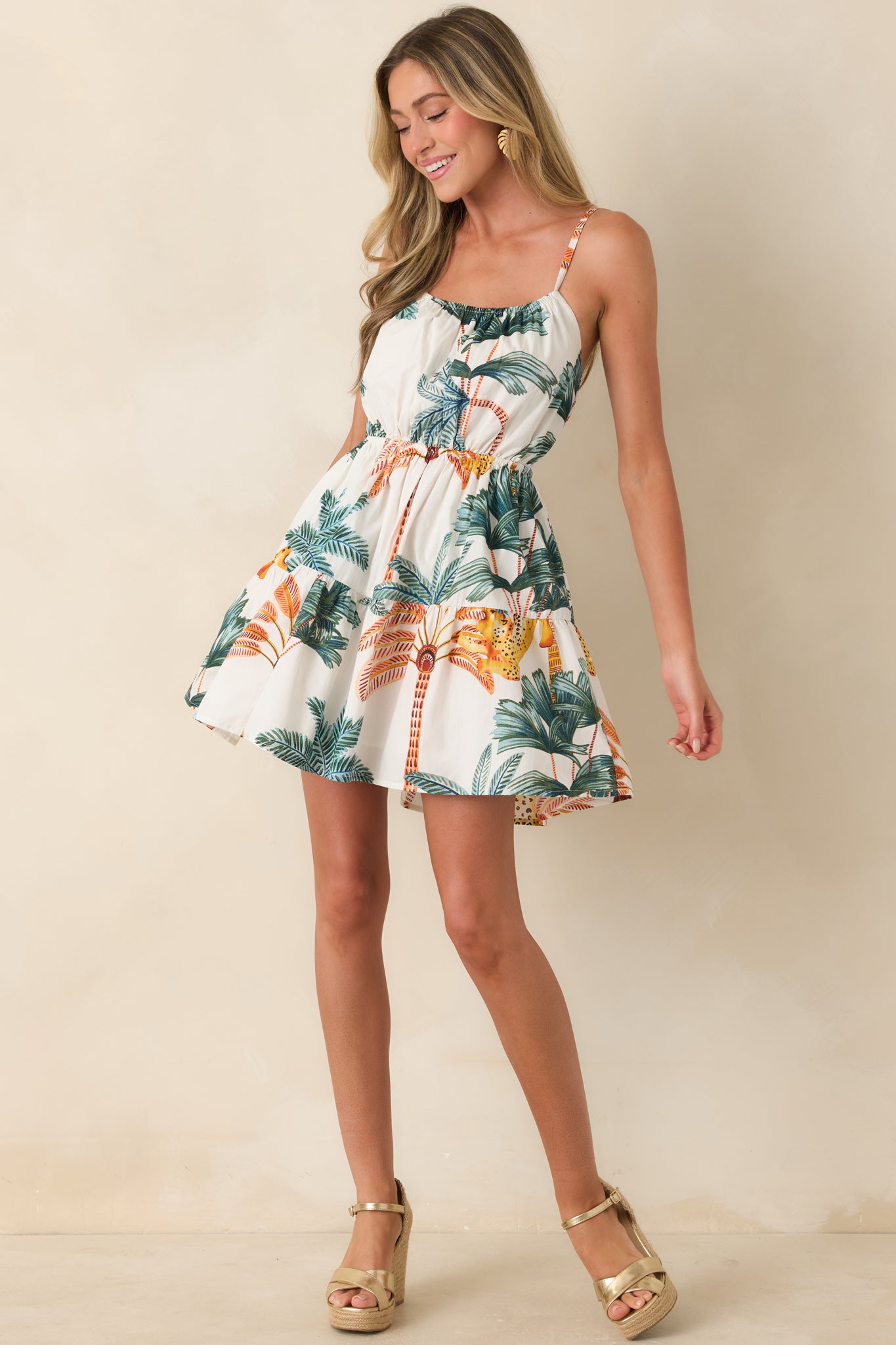 Palm print mini dress with soft tiers and lightweight cotton movement.
