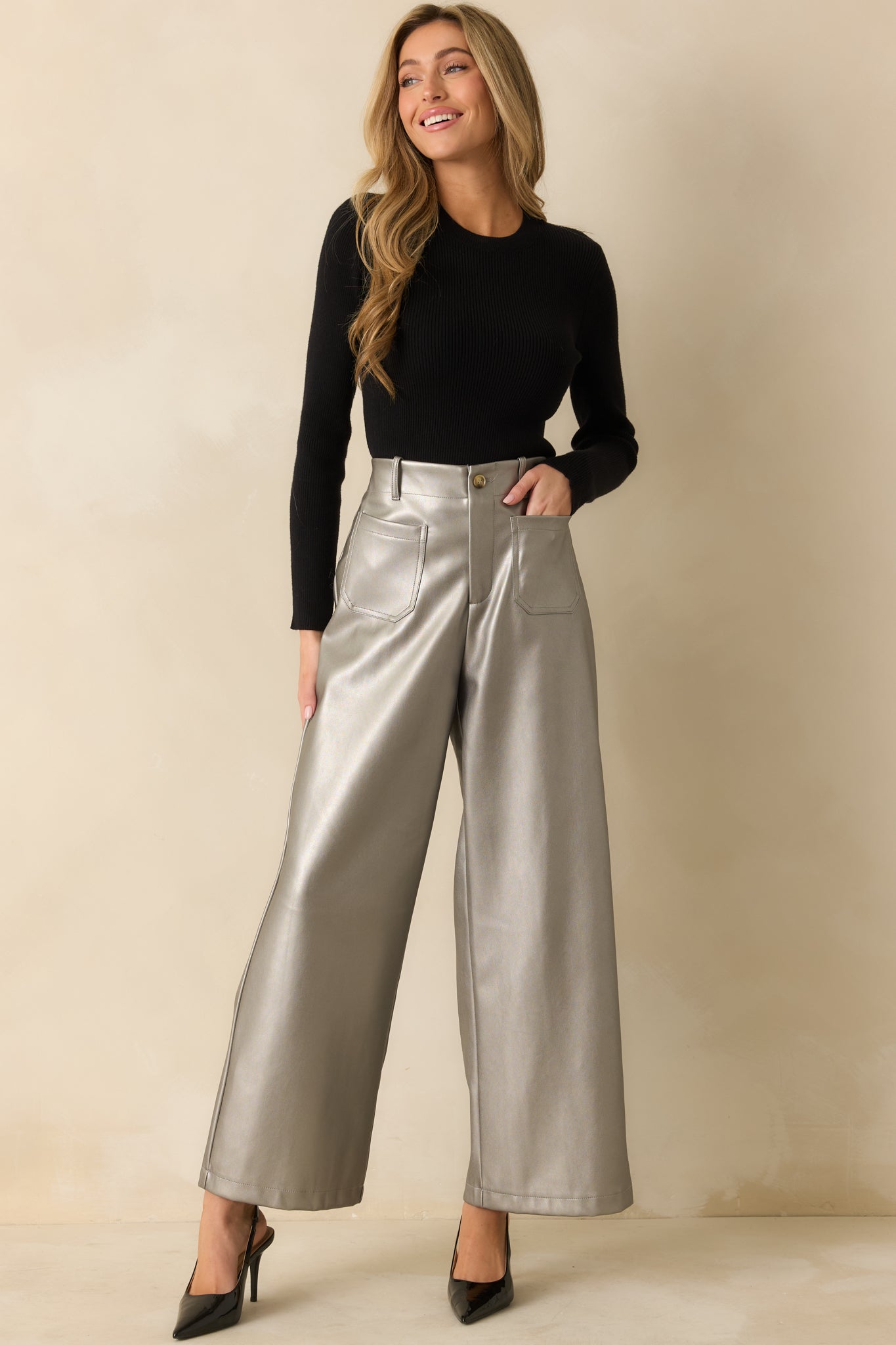 Reflective grey metallic pants styled with a structured high waist and crisp wide leg shape.