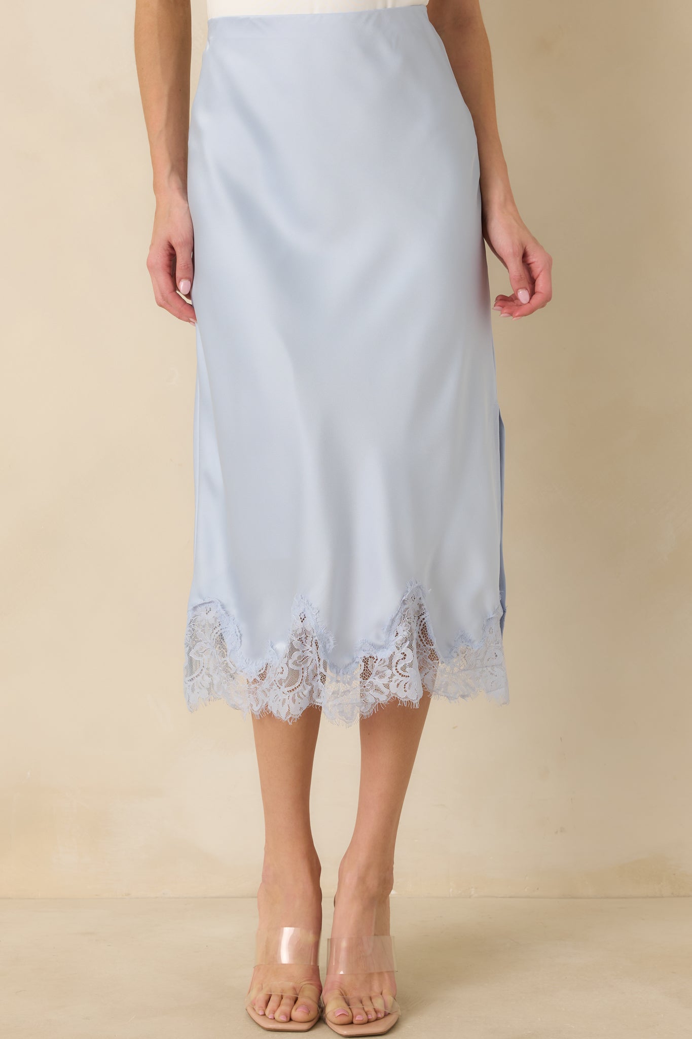 Partial front view showing the sleek straight cut and subtle sheen of the blue midi skirt.