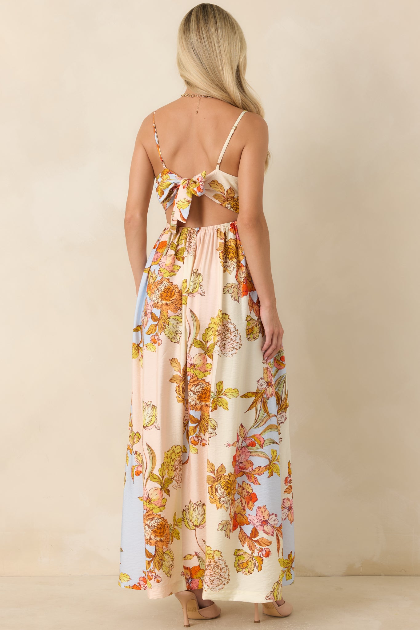Back of the pastel floral maxi dress featuring an open-back design with an adjustable self-tie closure.