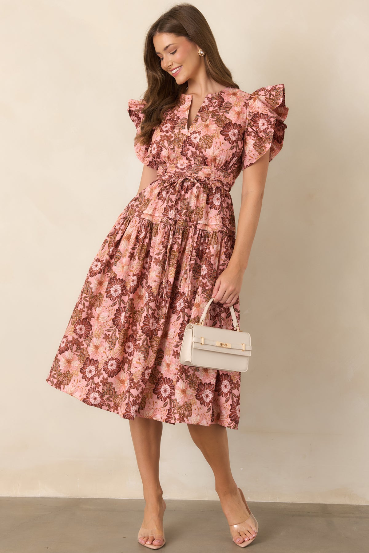 Pastel pink and rich brown floral print dress with a V-neckline, short ruffle sleeves, defined waist, and softly gathered flowing skirt.