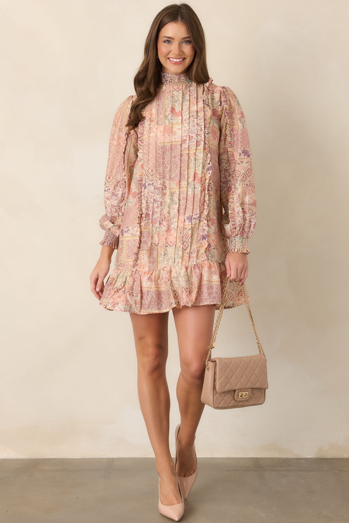 Patchwork-inspired mini dress featuring paisley, floral, and geometric motifs.