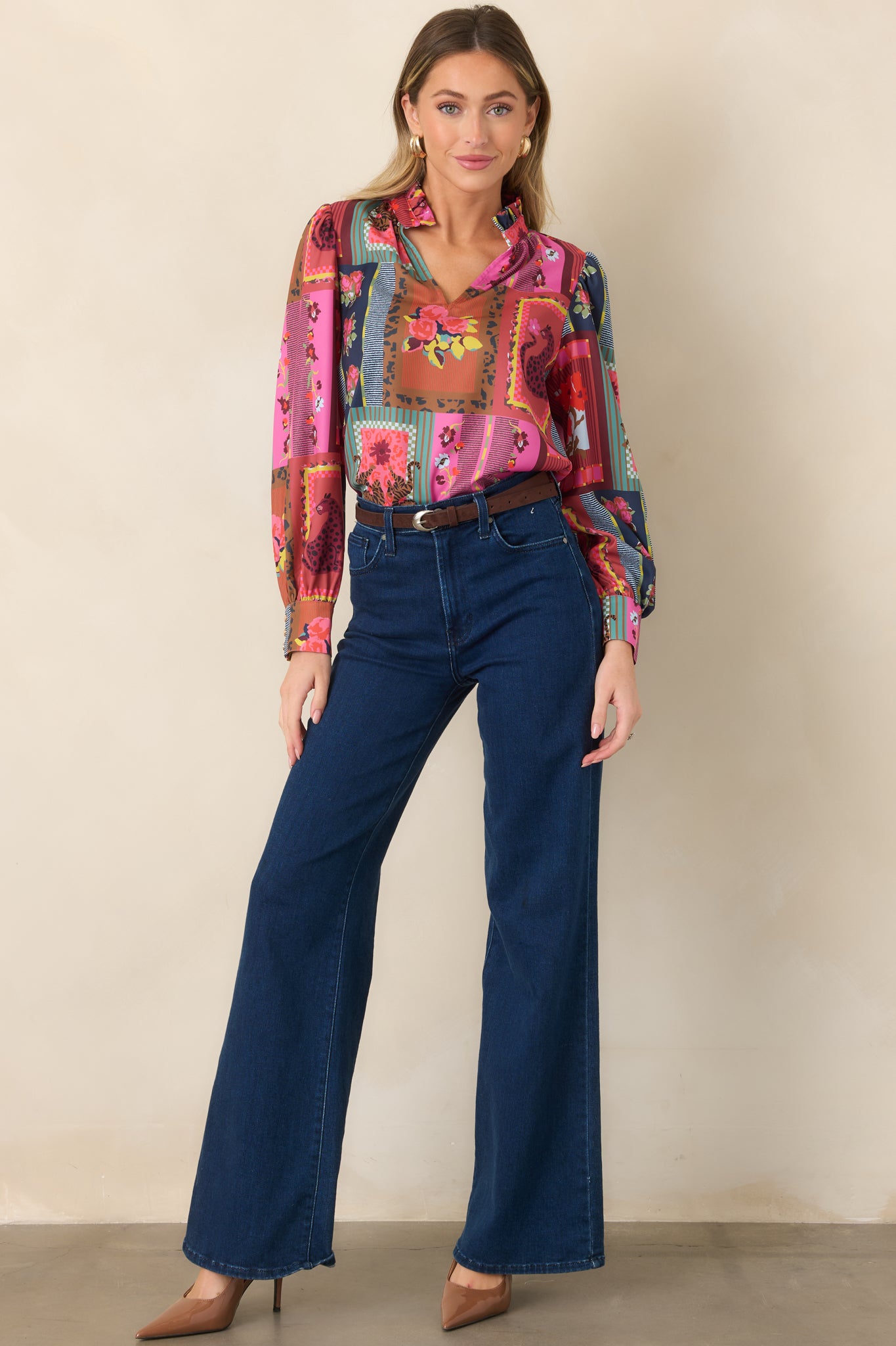 Drapey printed top showcasing its patchwork-inspired mix of florals, framed motifs, colorful stripes, and relaxed blouson sleeves.