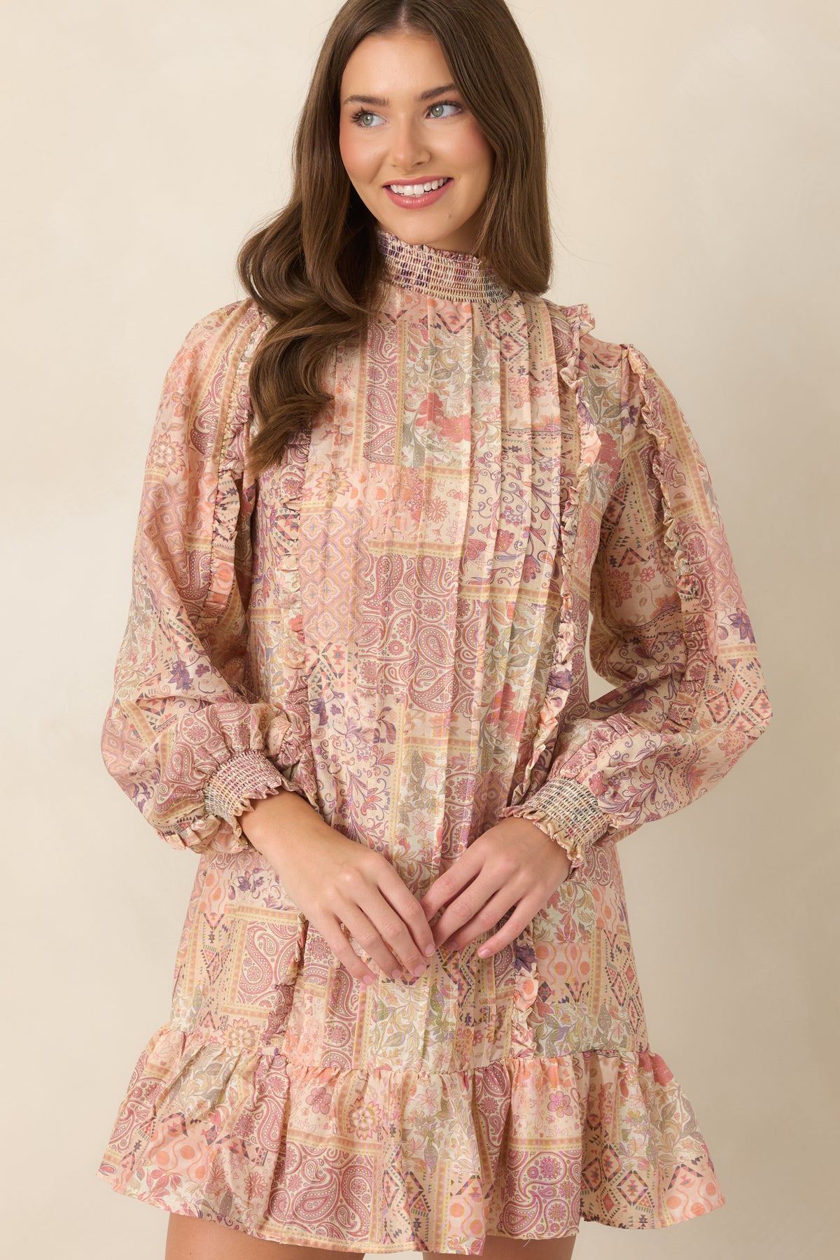 Patchwork print dress highlighting vertical pintucks and delicate ruffle trim.