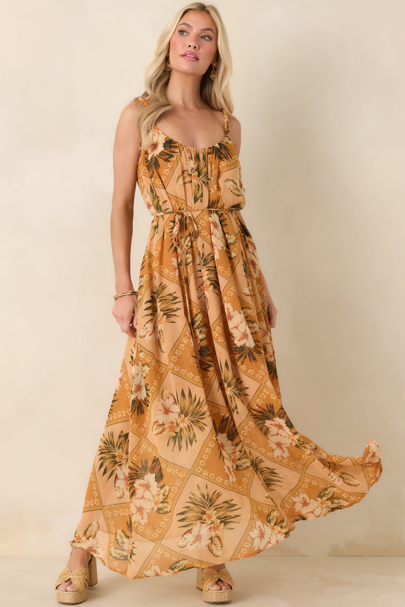 Front view of a peach multi tropical print maxi dress with beaded straps, gathered neckline, and flowing silhouette.