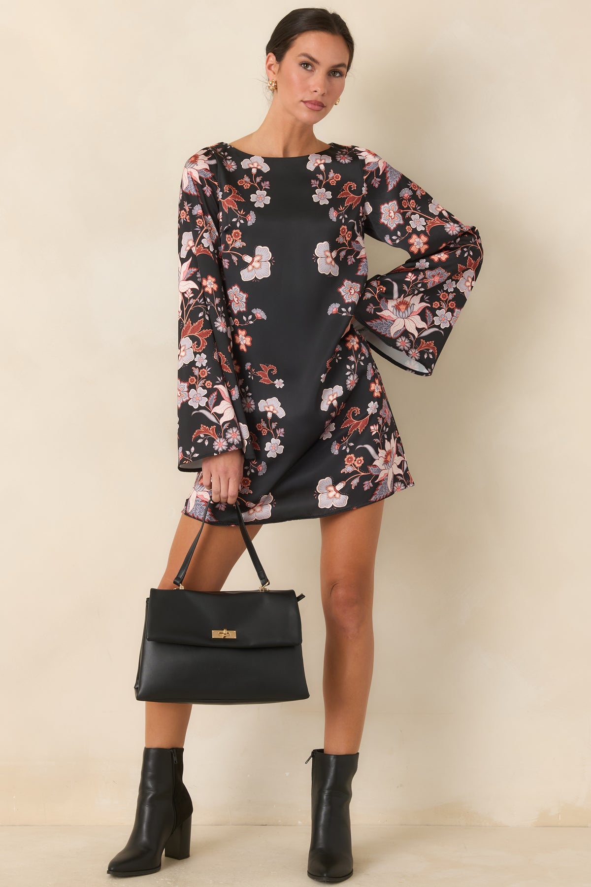 Periwinkle, ivory, and rust floral mini dress with a smooth satin finish and dramatic sleeves.
