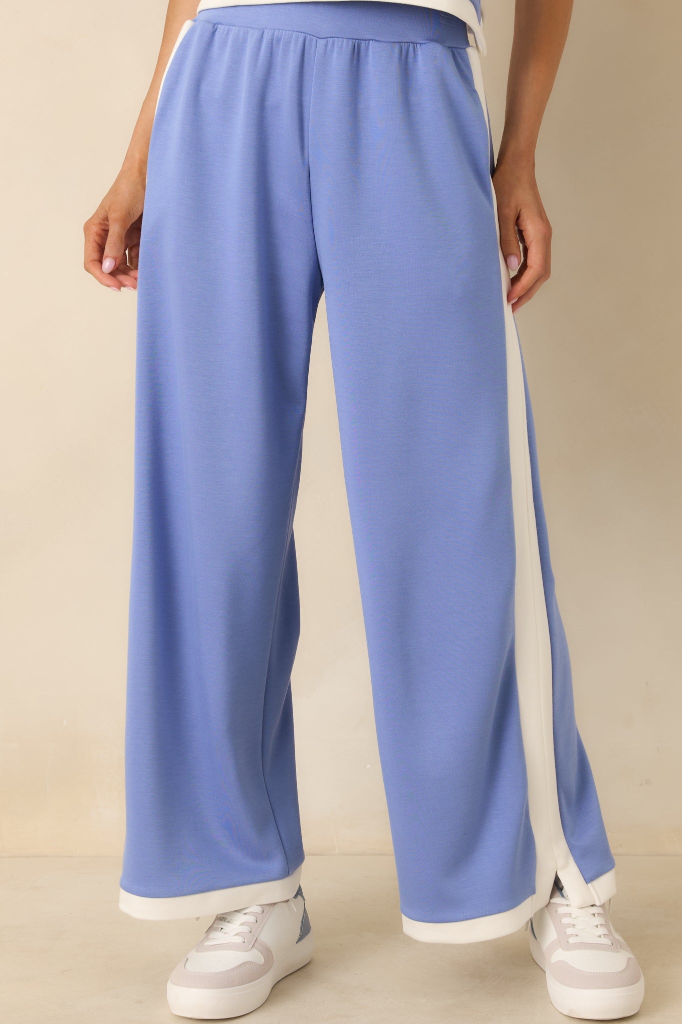 Periwinkle knit pants showing contrast hem trim with soft, stretchy texture.