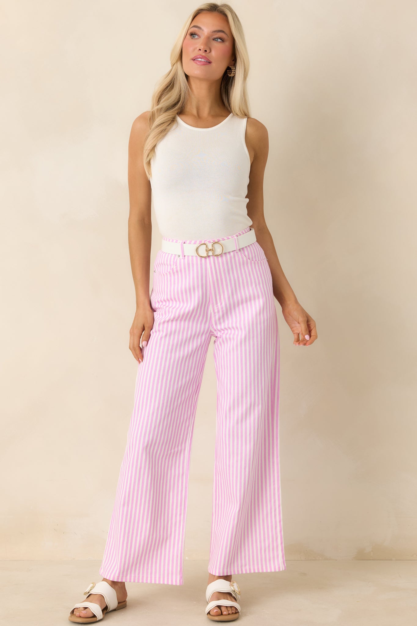 Pink and white striped cotton pants with structured silhouette and vertical stripe design.