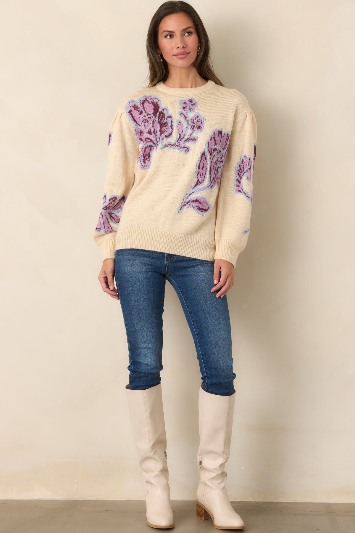 Pink and burgundy flowers with pale blue outlines stand out against the soft vanilla background of this relaxed knit top.