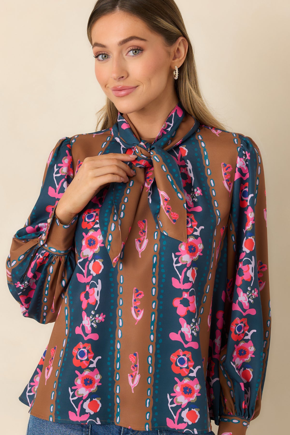 Pink, coral, and lilac florals stand out against alternating blue and caramel stripes with dotted accents.