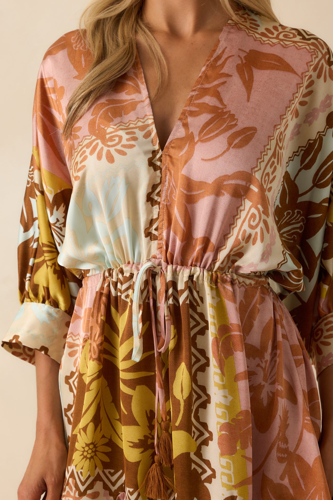 Pink coral mini dress detail showing the multicolor patchwork, adjustable drawstring, and godet hem flares.