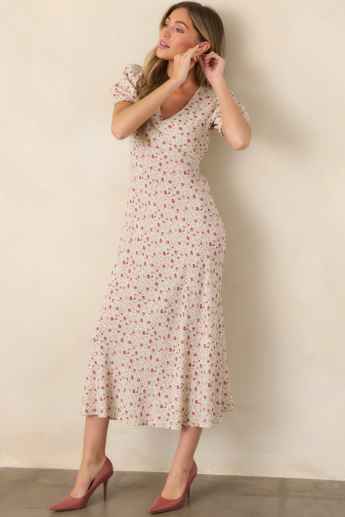 Pink multicolor floral maxi dress showcasing its flowing silhouette, V-neckline, elastic waist, puff sleeves, and subtle leg slit.