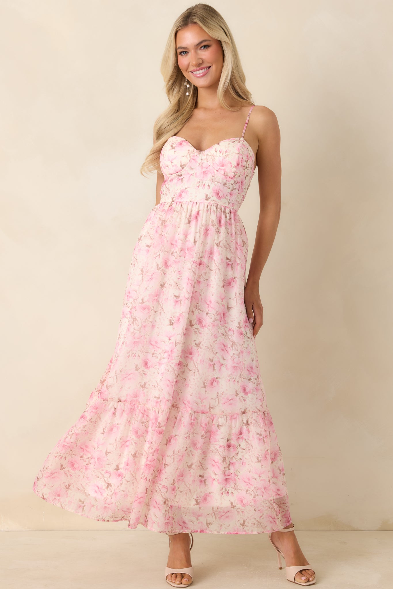 Pink floral midi dress with structured bust detail and delicate spaghetti straps.