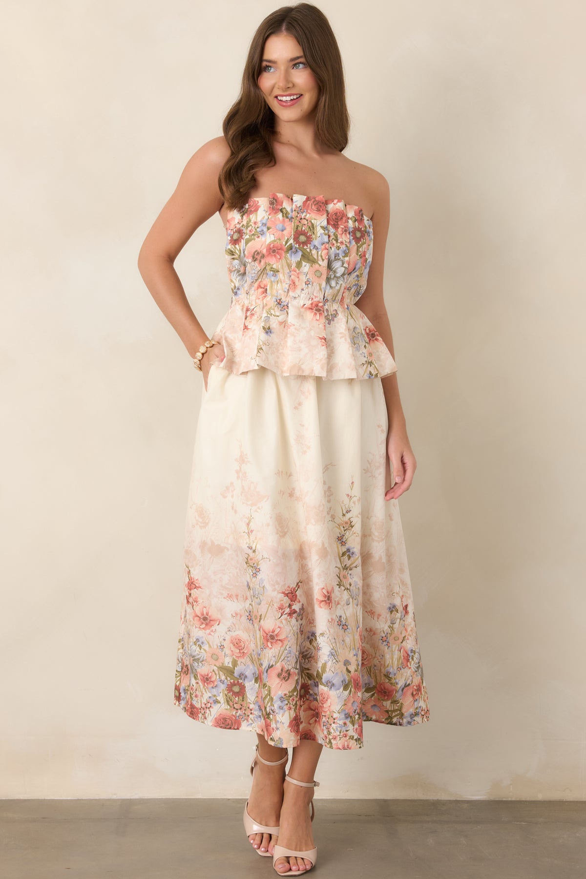 Pink floral midi dress with a secure strapless bodice, delicate pleating through the upper portion, and an easy flowing skirt.