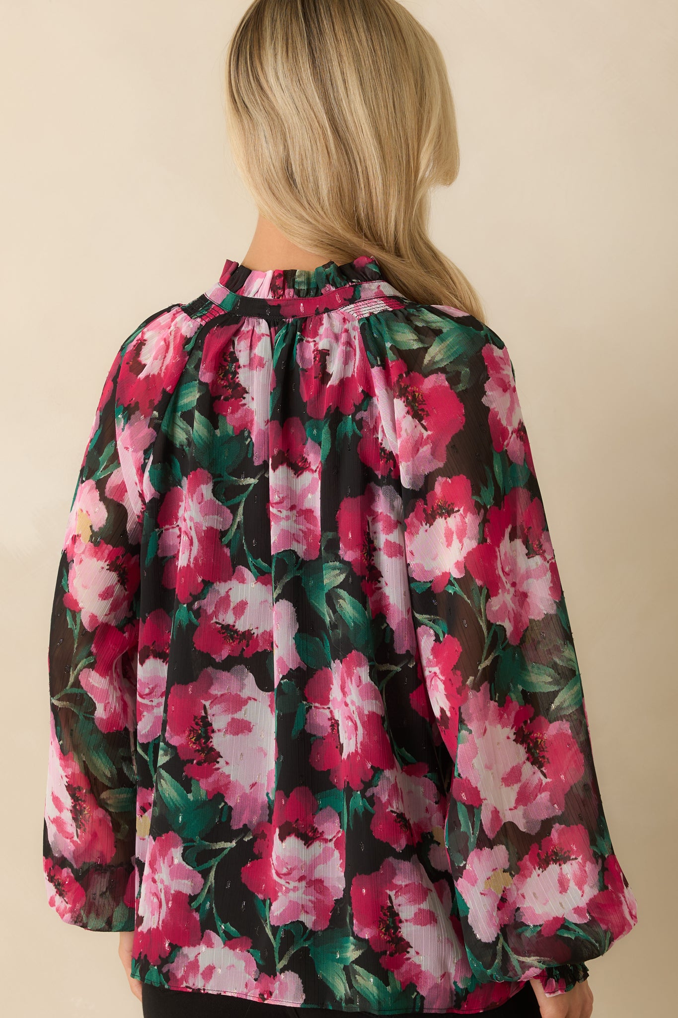 Rear view of the pink multi floral top showing the relaxed fit, long sheer sleeves, and continuous floral pattern.