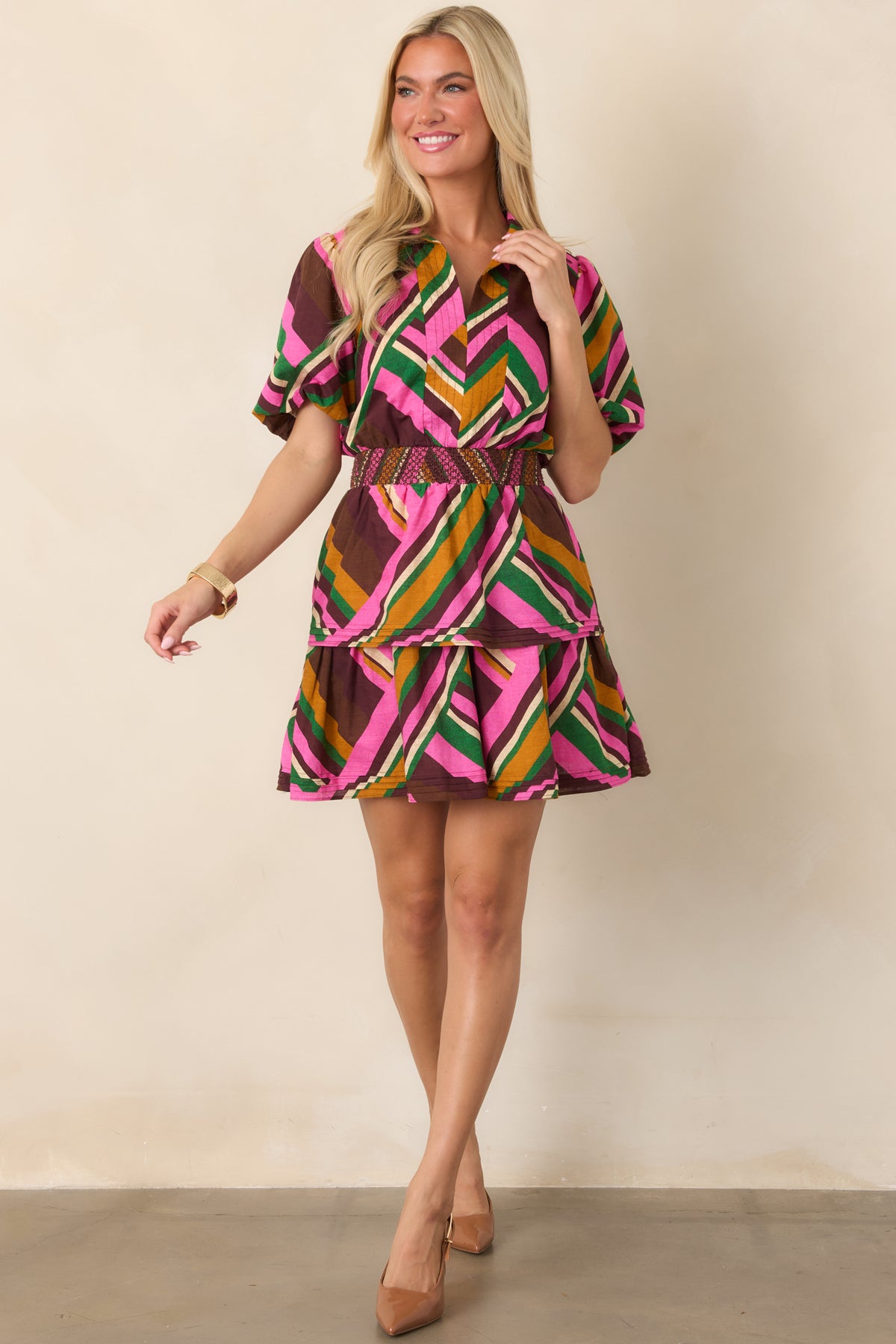 Cotton-linen mini dress featuring mixed-direction pink geometric stripes, voluminous puff sleeves, and an embroidered smocked waist.
