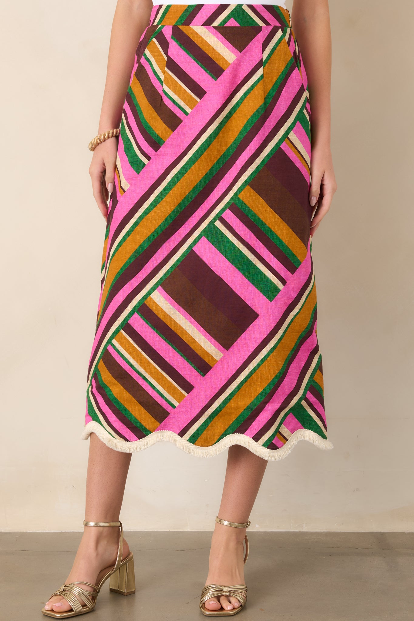 Geometric pink stripes create a bold pattern throughout this flared midi skirt, with side pockets adding everyday functionality.