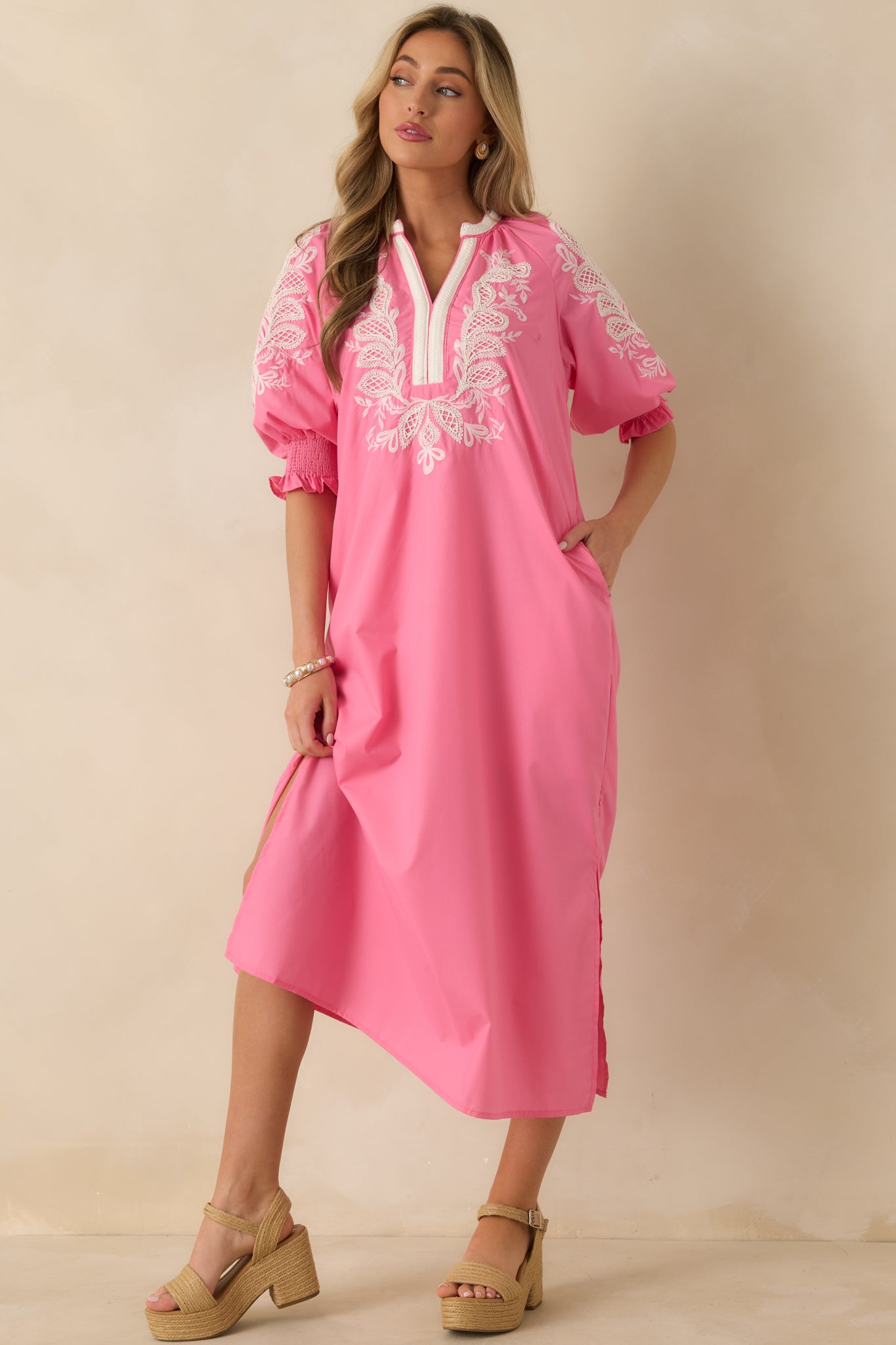 Pink maxi dress shown with soft movement in skirt and delicate embroidered detailing on upper bodice.