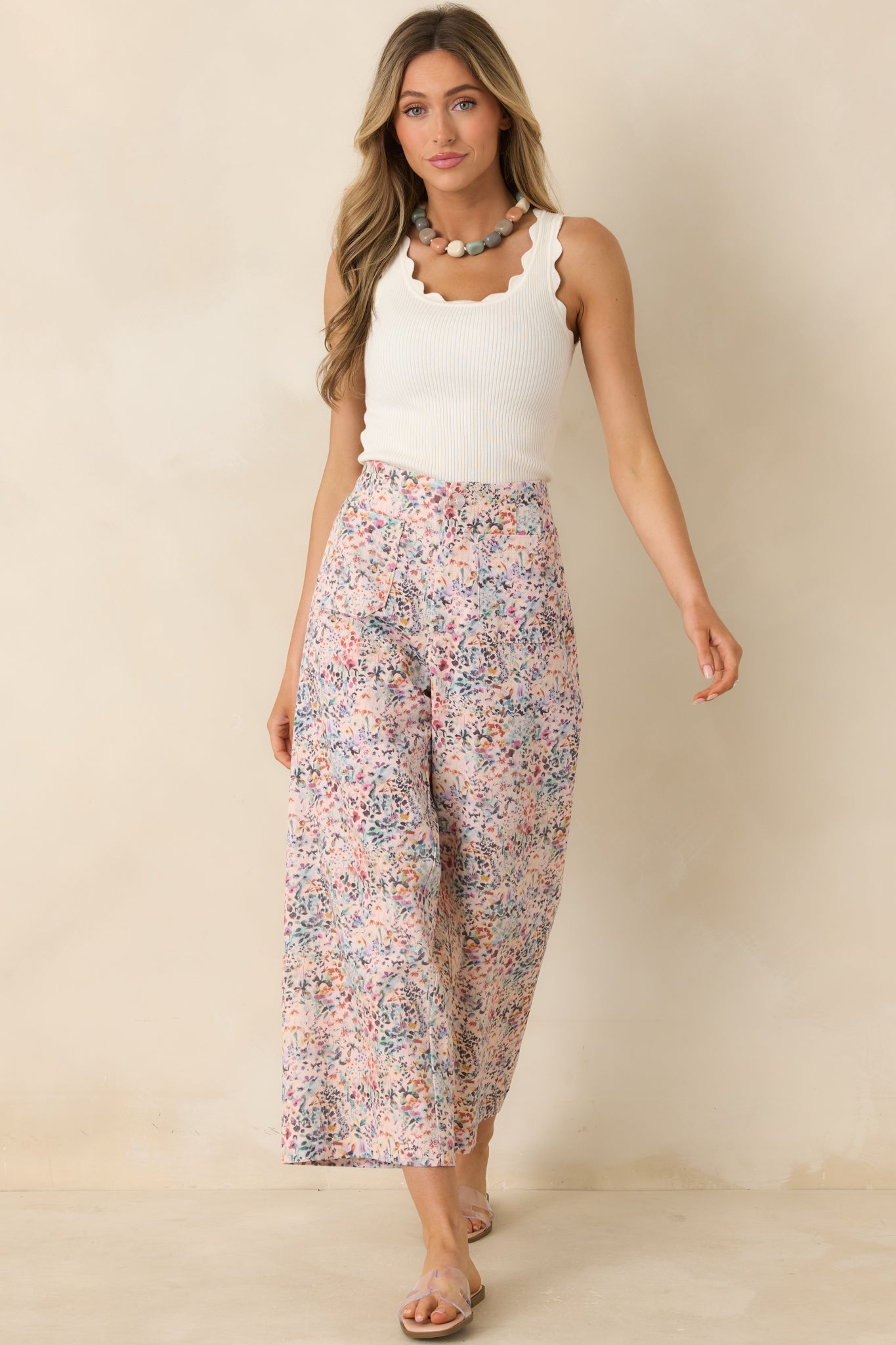Pink multi floral cotton pants with wide leg silhouette and structured waistband.