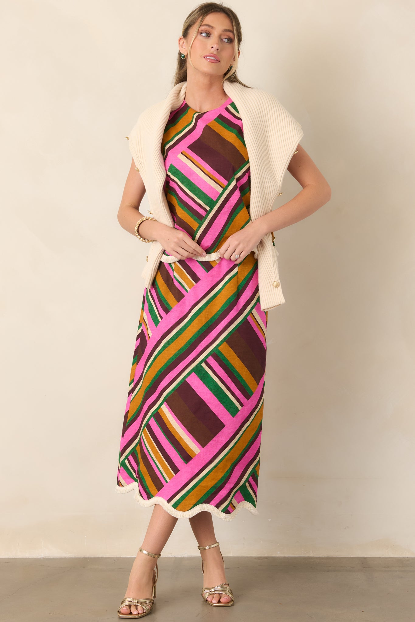 Pink multi geometric striped sleeveless top with a round neckline, relaxed silhouette, and scalloped fringe-trim hem.