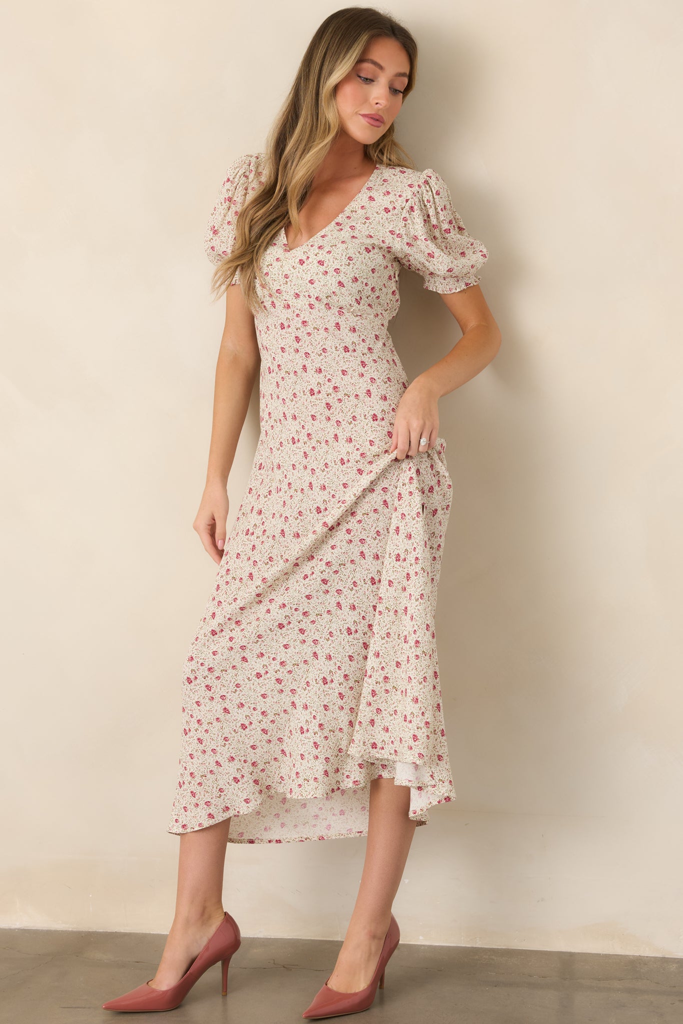 Pink multicolor floral maxi dress featuring a V-neckline, short puff sleeves, elastic waist, and small leg slit.