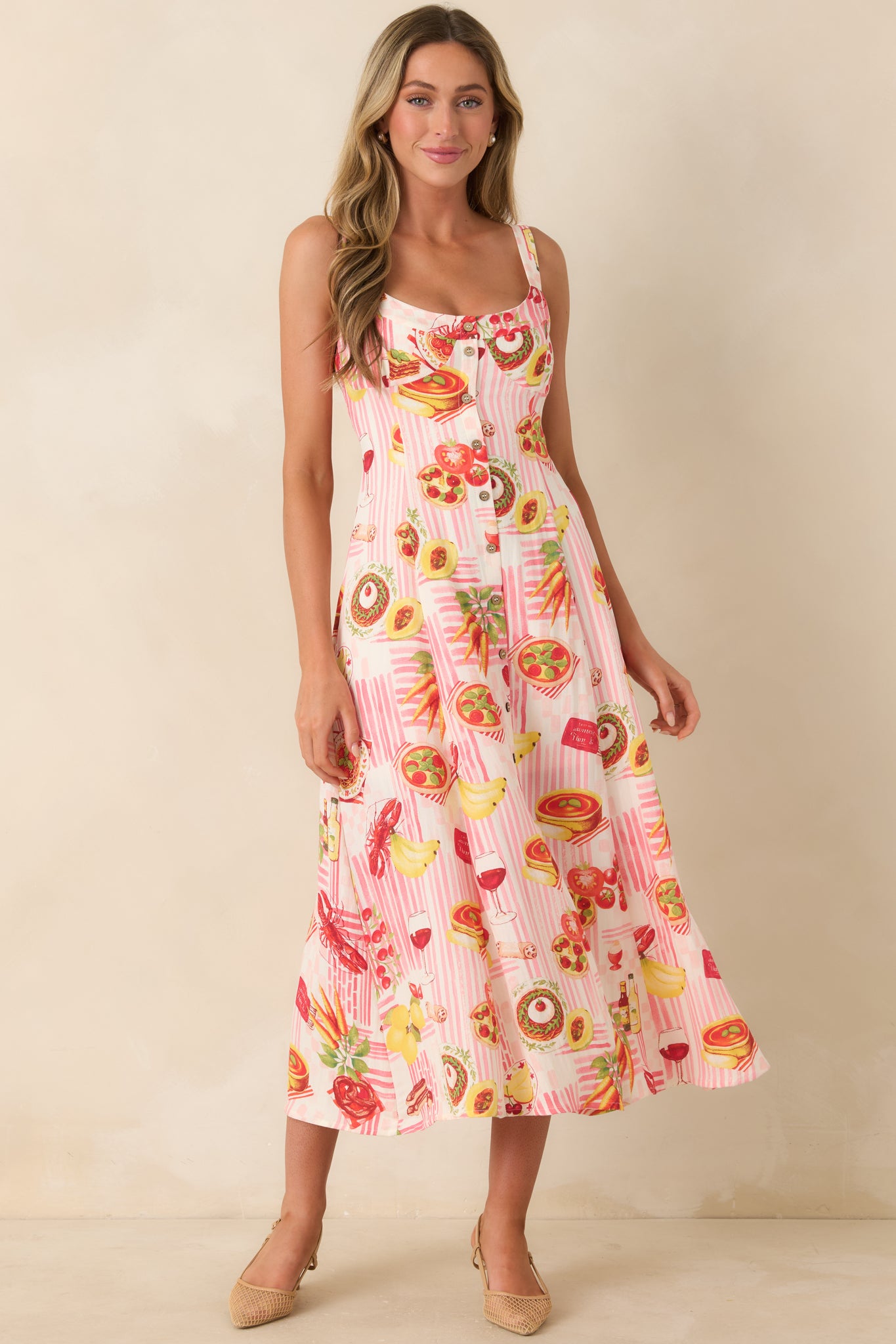 Pink and white striped midi dress showcasing a colorful food-inspired pattern, breezy shape, scoop neckline, and functional button detailing.
