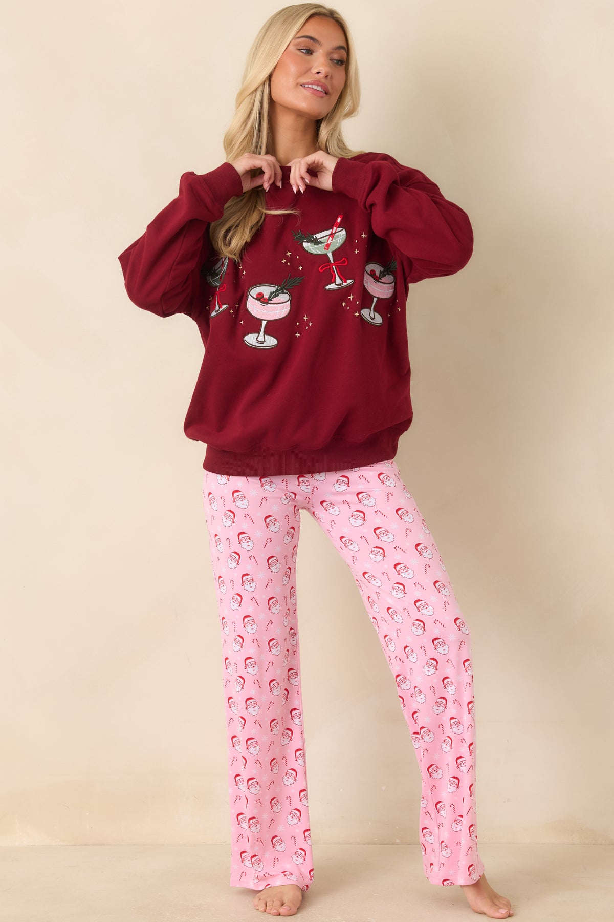 Light pink full-length pajama pants combine a playful Santa print with an elastic waistband and comfortable fit.