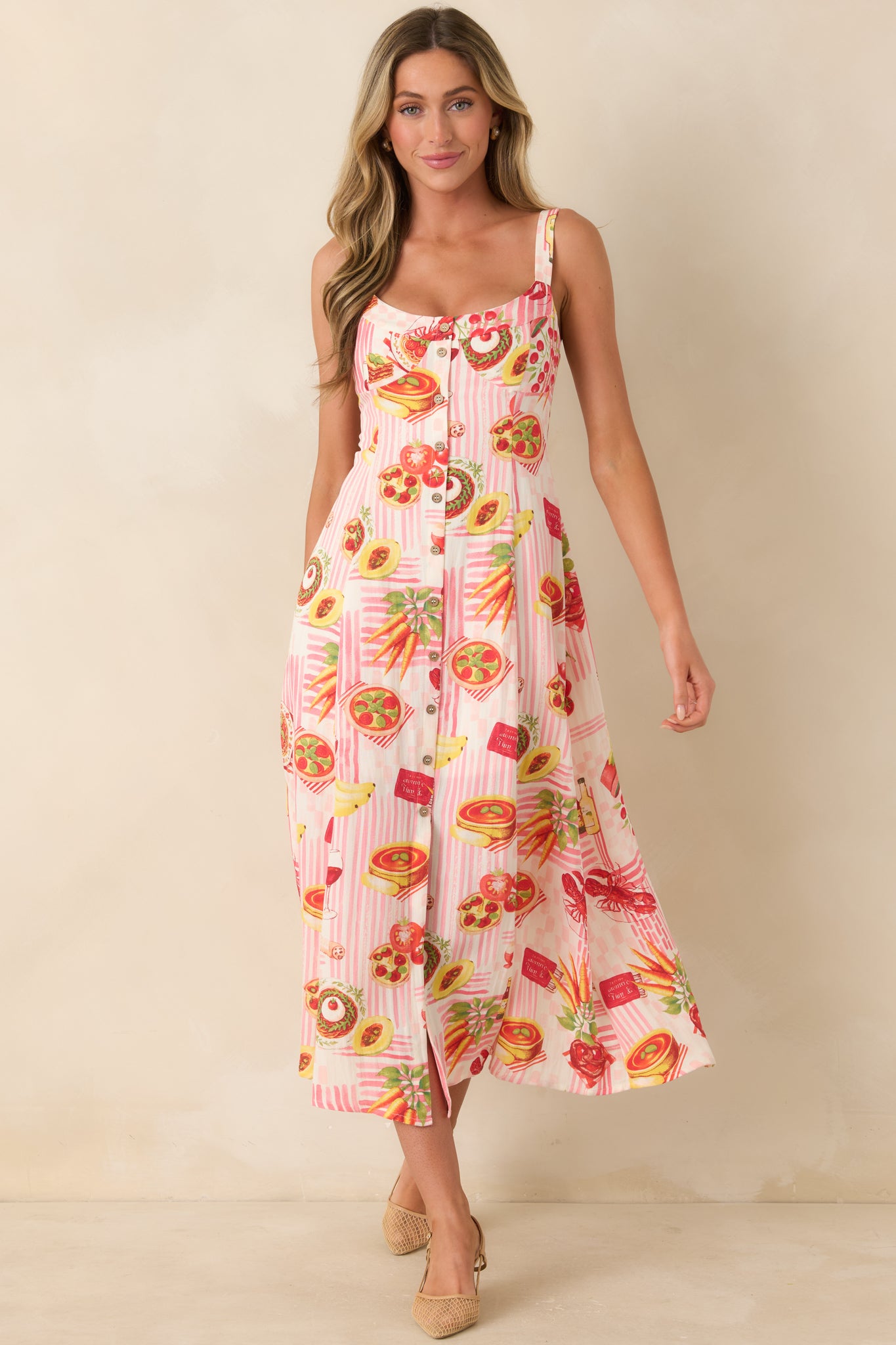 Pink striped midi dress featuring a playful food-inspired print, relaxed flowing shape, scoop neckline, and functional button front for an easy everyday style.
