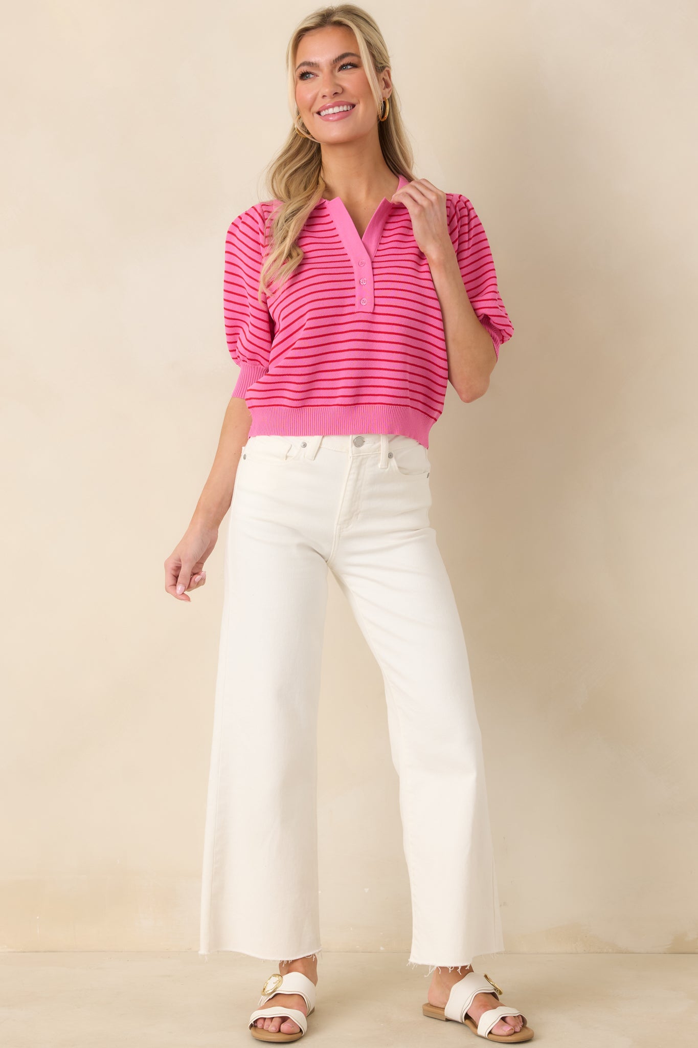Pink striped knit top with short puff sleeves, ribbed edges, and a comfortable, slightly relaxed fit for casual styling.