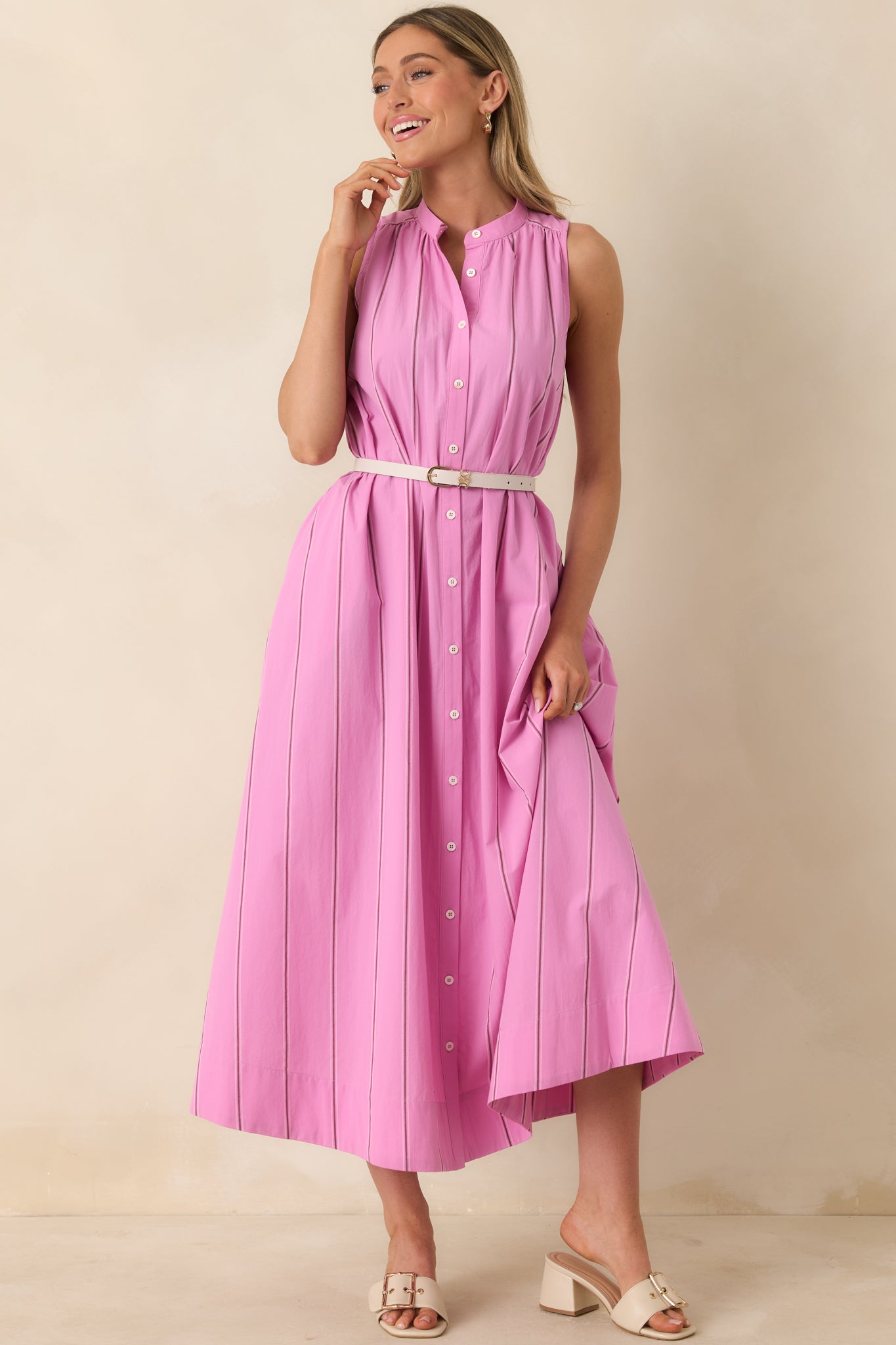 Pink striped maxi dress with gathered yoke, button front, and flowing silhouette.