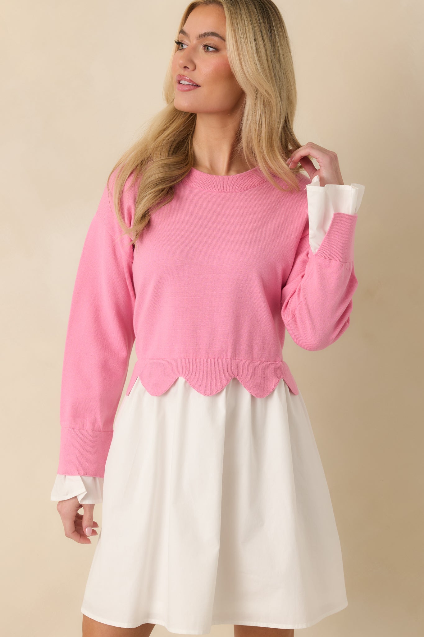 Close front view emphasizing the contrast between the knit sweater bodice and woven skirt on the pink and white mini dress.