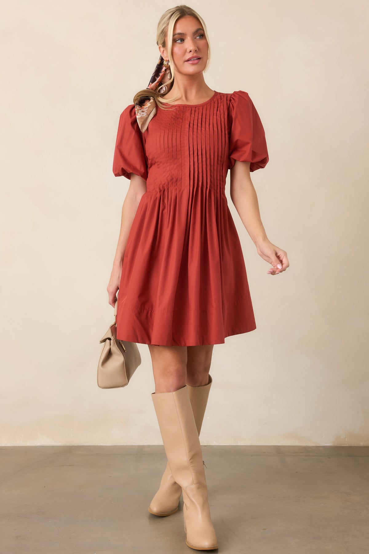 Mini dress featuring detailed pintucking across the bodice, voluminous short puff sleeves, and a full softly gathered skirt with side pockets.