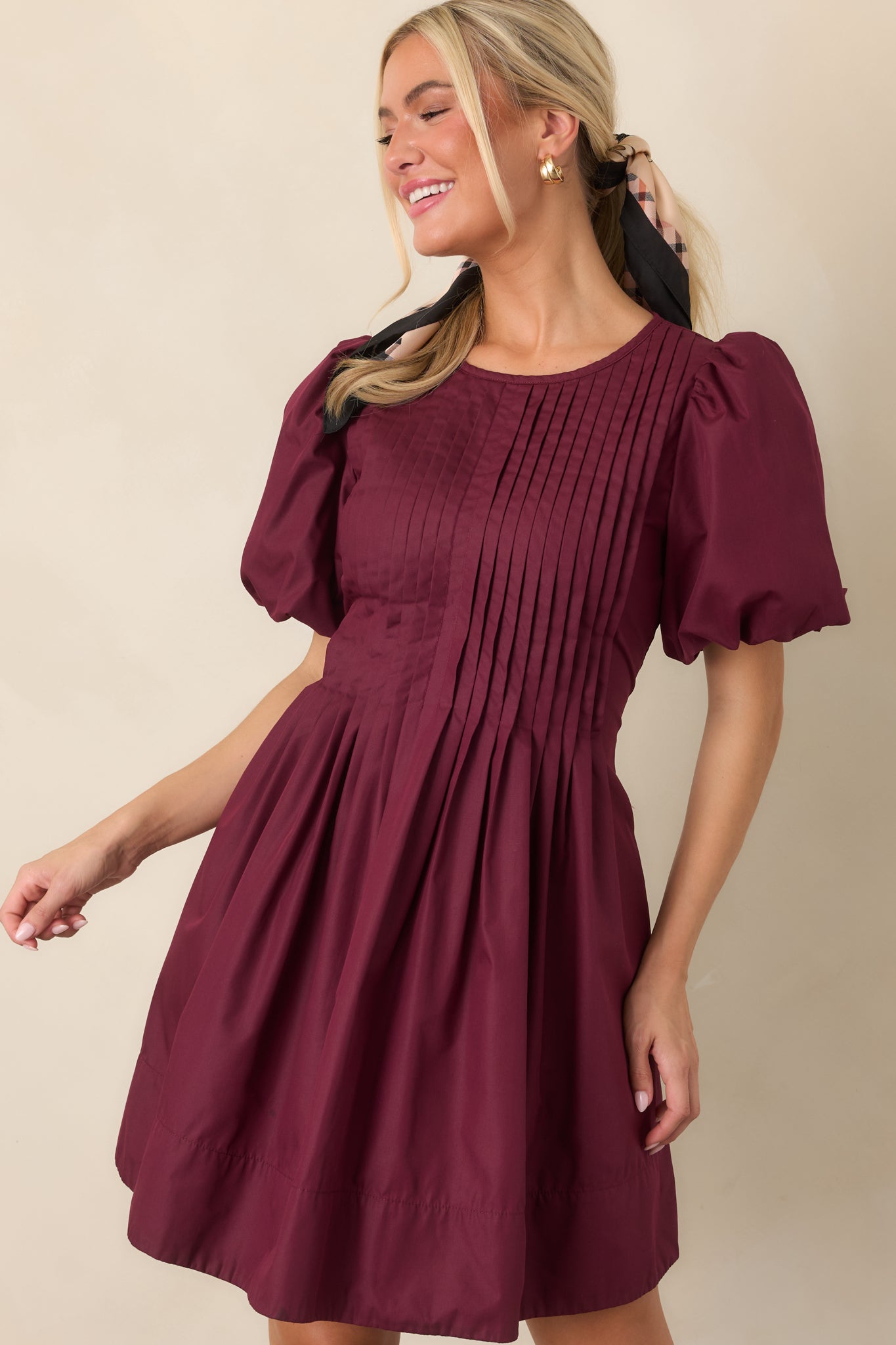 Close view of the pintucked dress emphasizing the dimensional bodice texture, softly gathered skirt, and smooth lined construction.