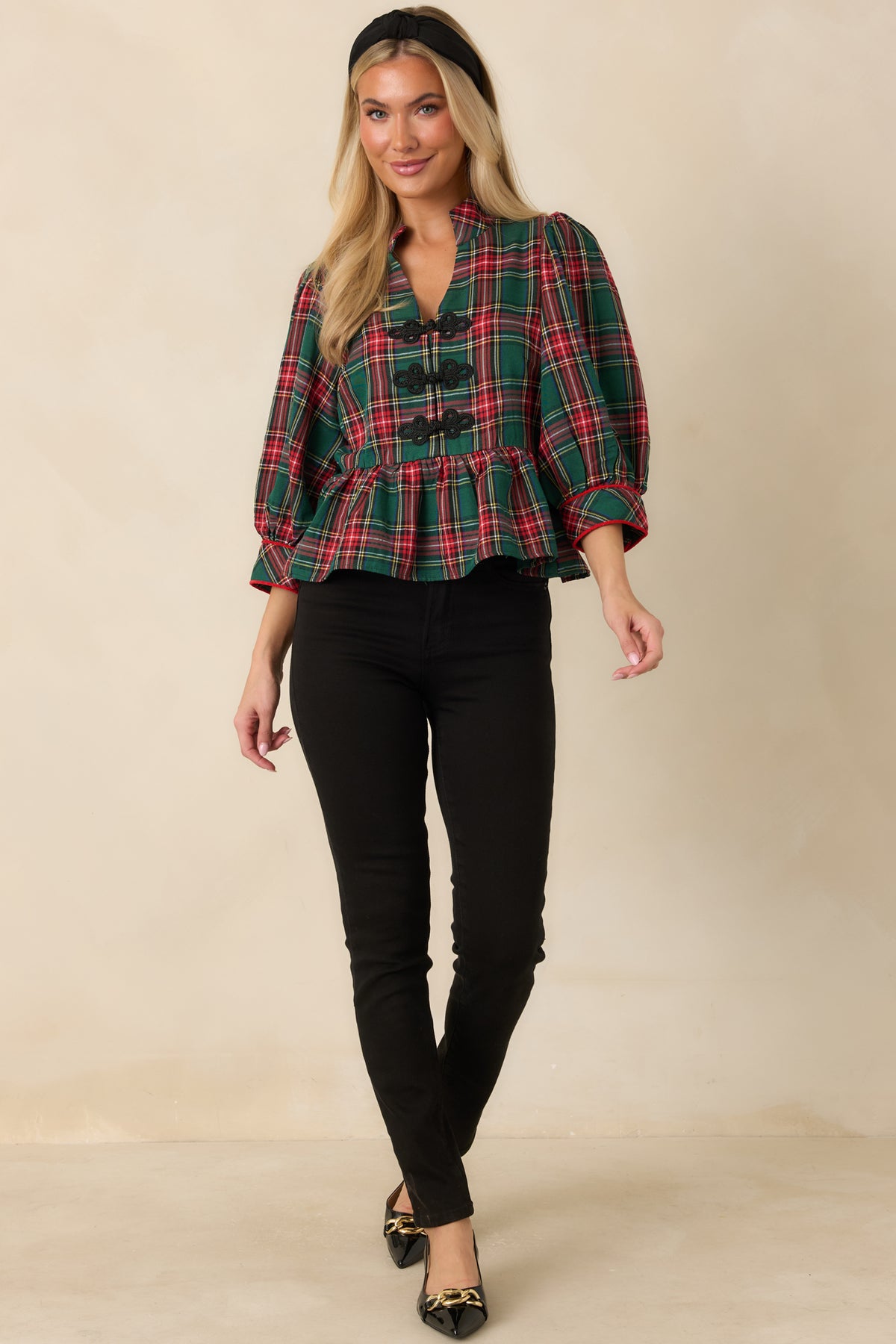 Plaid blouse with black braided frog closures, three-quarter sleeves, and a gathered waist.